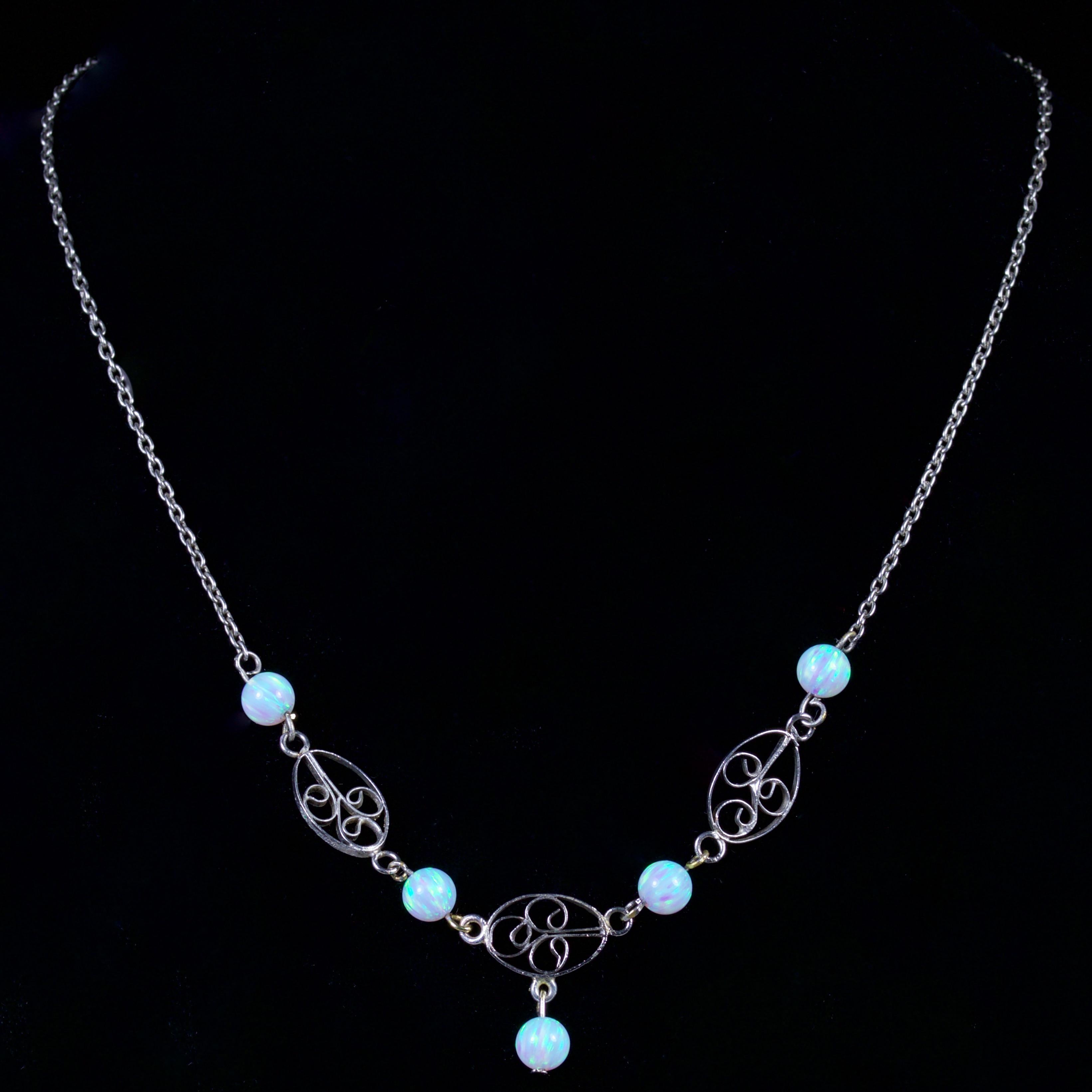 This elegant Victorian Sterling Silver necklace is, Circa 1900.

The necklace 4 cultured Opal set into a fancy Silver gallery, that leads down to another cultured Opal dropper.

Each cultured Opal is 0.75ct

Cultured Opals radiate a myriad of