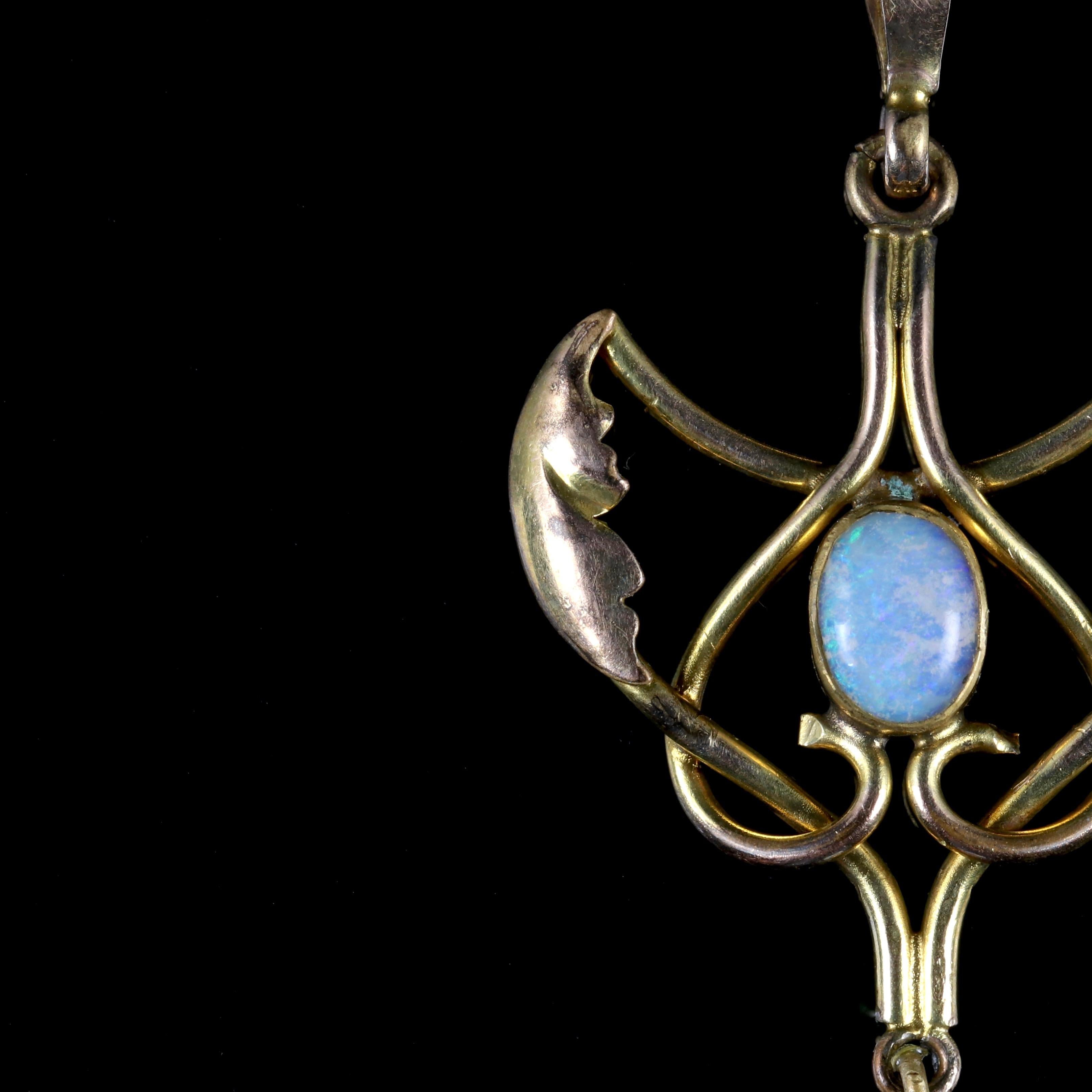 This beautiful Victorian 9ct Yellow Gold pendant is, Circa 1900.

The pendant is in an ornate design with a colourful Opal in the centre with a another Opal ball dropper. 

The Opals reflect a myriad of hues such as blues, green, pinks, turquoise as