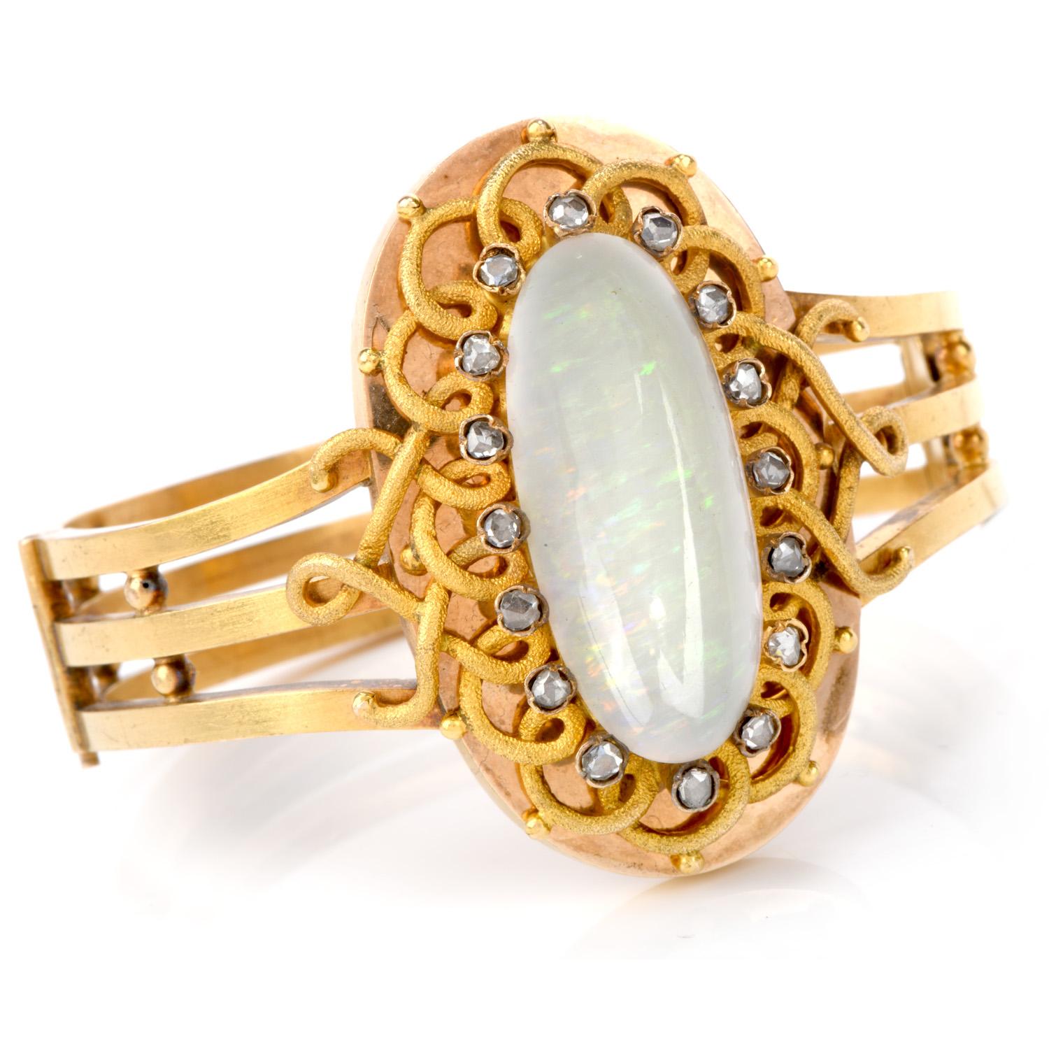 A classic piece from the end of the 19th century is crafted in 14k gold. This Antique Victorian treasure features an opal measuring approx. 30mm x 13mm, weighing approx. 12.70 carats, surrounded by 15 rose-cut diamond weighing approx. 0.60 carats