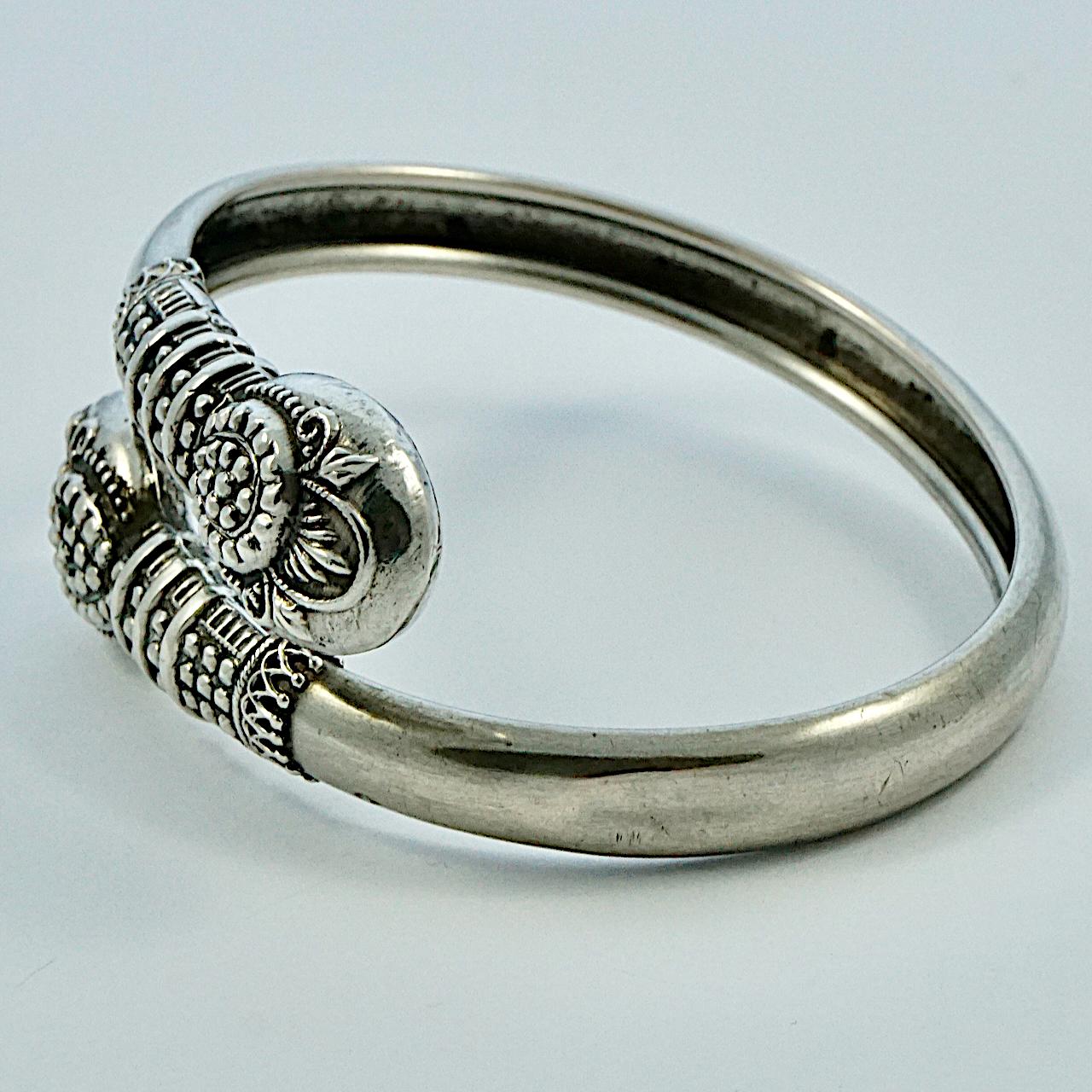 
Beautiful lightweight Victorian silver bangle with ornate decoration. The ornate front pieces test for silver, the band is silver tone. It is slightly oval, the inside measurements are 5.5 cm / 2.1 inches by 4.5 cm / 1.8 inches, and the width is 7