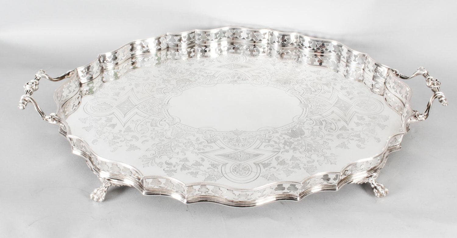 This is a large beautiful antique English Victorian oval silver plated twin handled tray, bearing the makers mark John Round and Sons, circa 1870.
 
The tray features beautifully chased vine and acanthus decoration with a monogrammed initials to