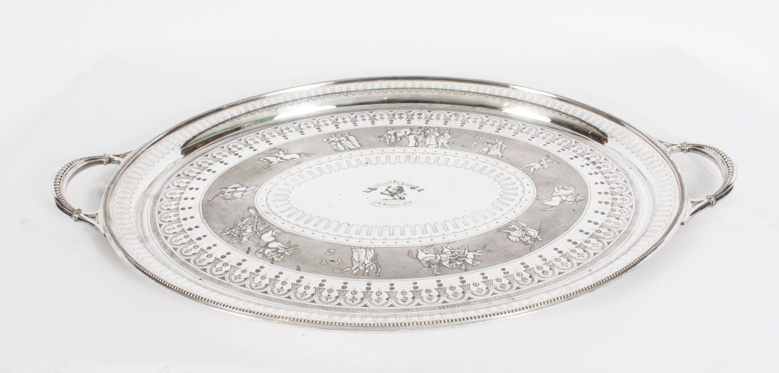 This is a momumental beautiful antique English Victorian neo-classical oval silver-plated twin handled tray by the renowned silversmith Walker & Hall, circa 1880 in date.
 
This large oval silver plated tray has elegant engraved stylised c-scrolls