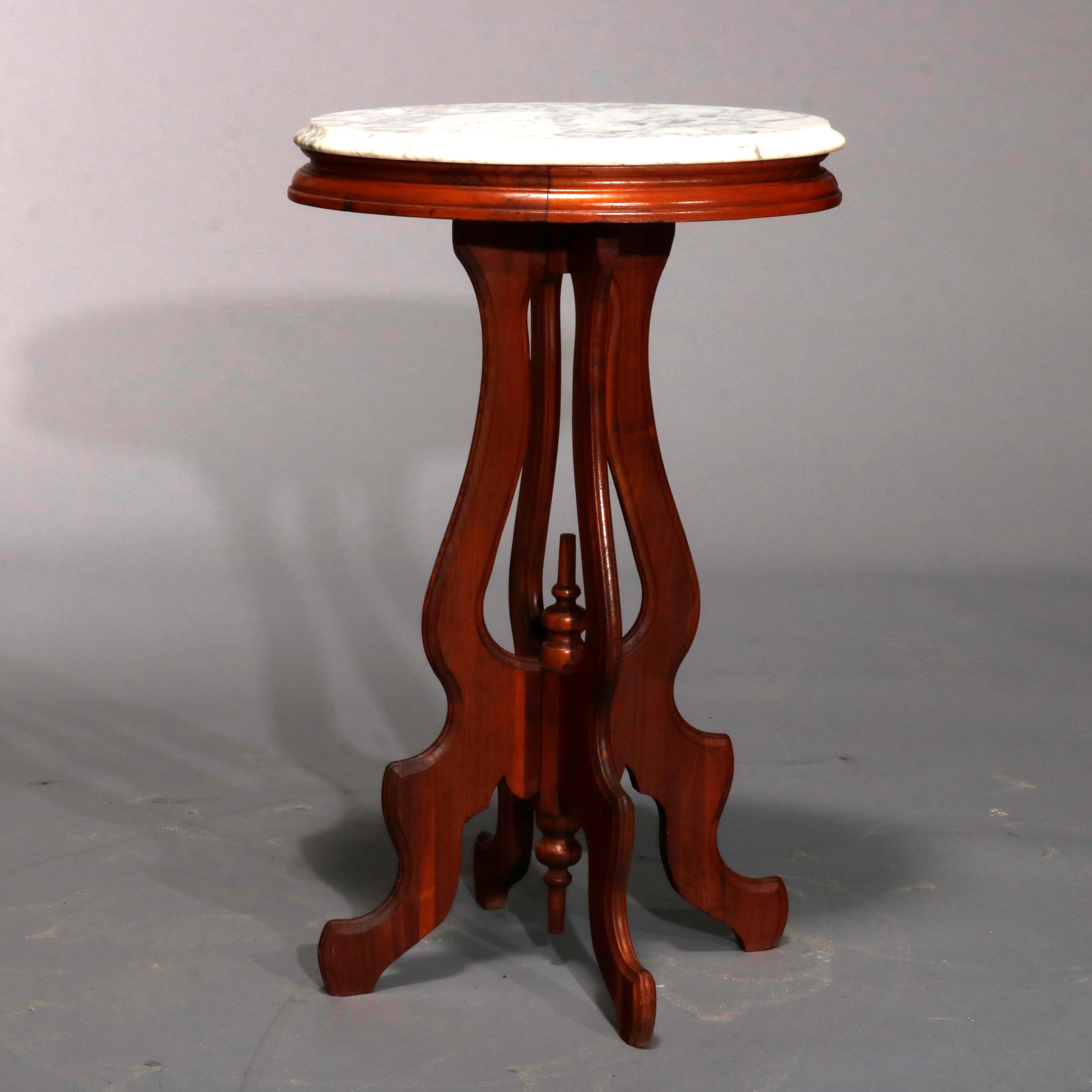 An antique Victorian plant stand offers oval and beveled marble top surmounting carved walnut stand with s-scroll legs having central finial and raised on cabriole legs, circa 1900.

Measures- 29