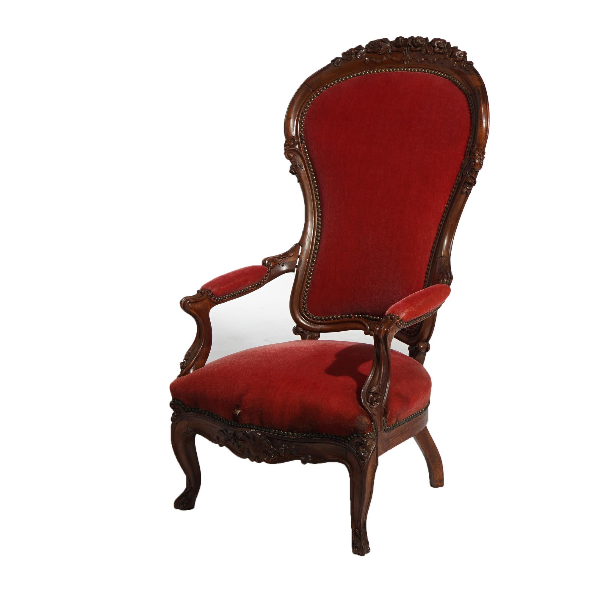 An antique Victorian parlor chair offers oversized walnut frame with foliate carved crest, upholstered seta and back, and raised on cabriole legs, c1890

Measures - 47