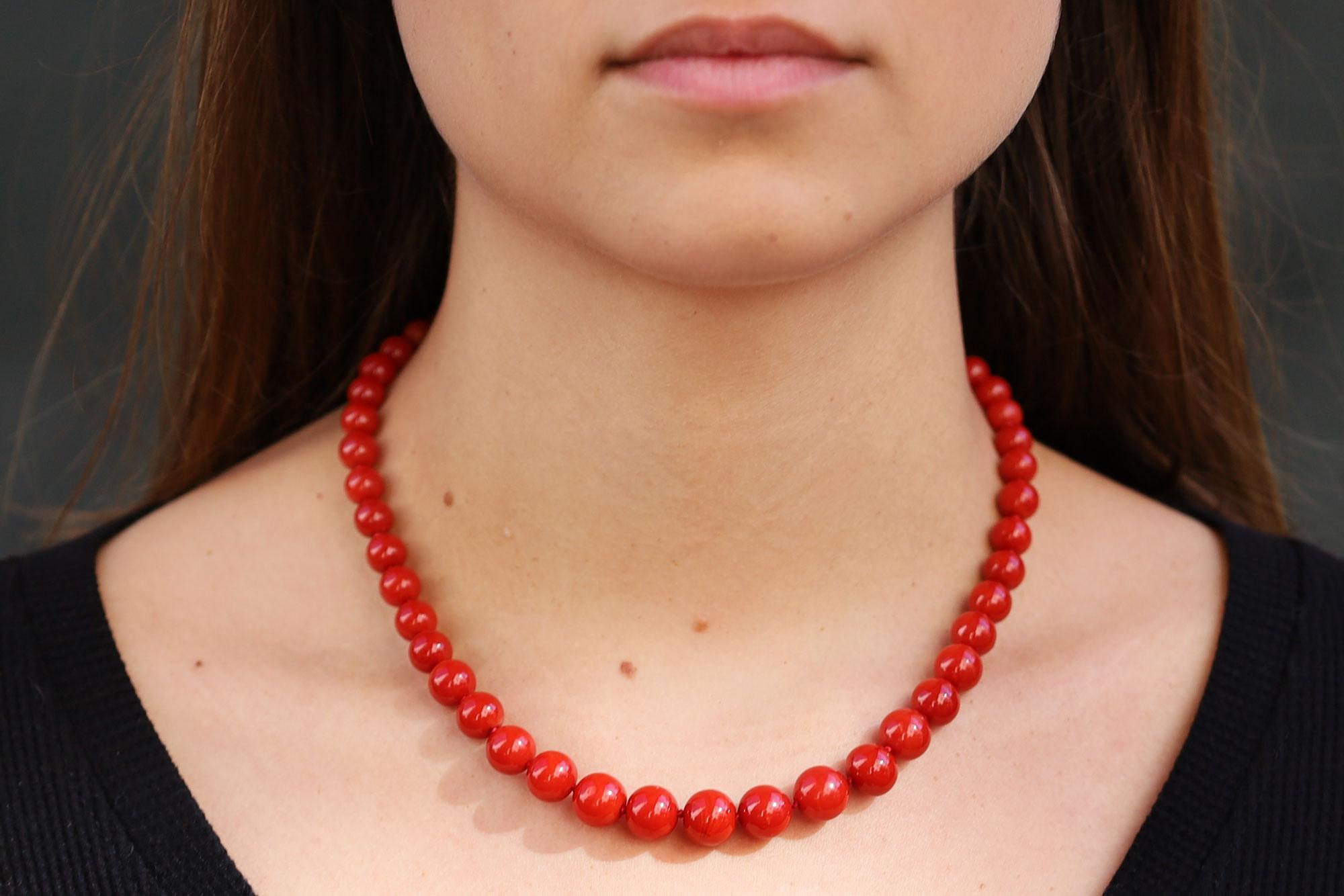 This antique Victorian era Mediterranean coral necklace is lively with old world charm and retro Hollywood glam. 44 natural ox blood coral beads are well matched in a graduated layout, undyed and rich with a deep red hue. In excellent condition,