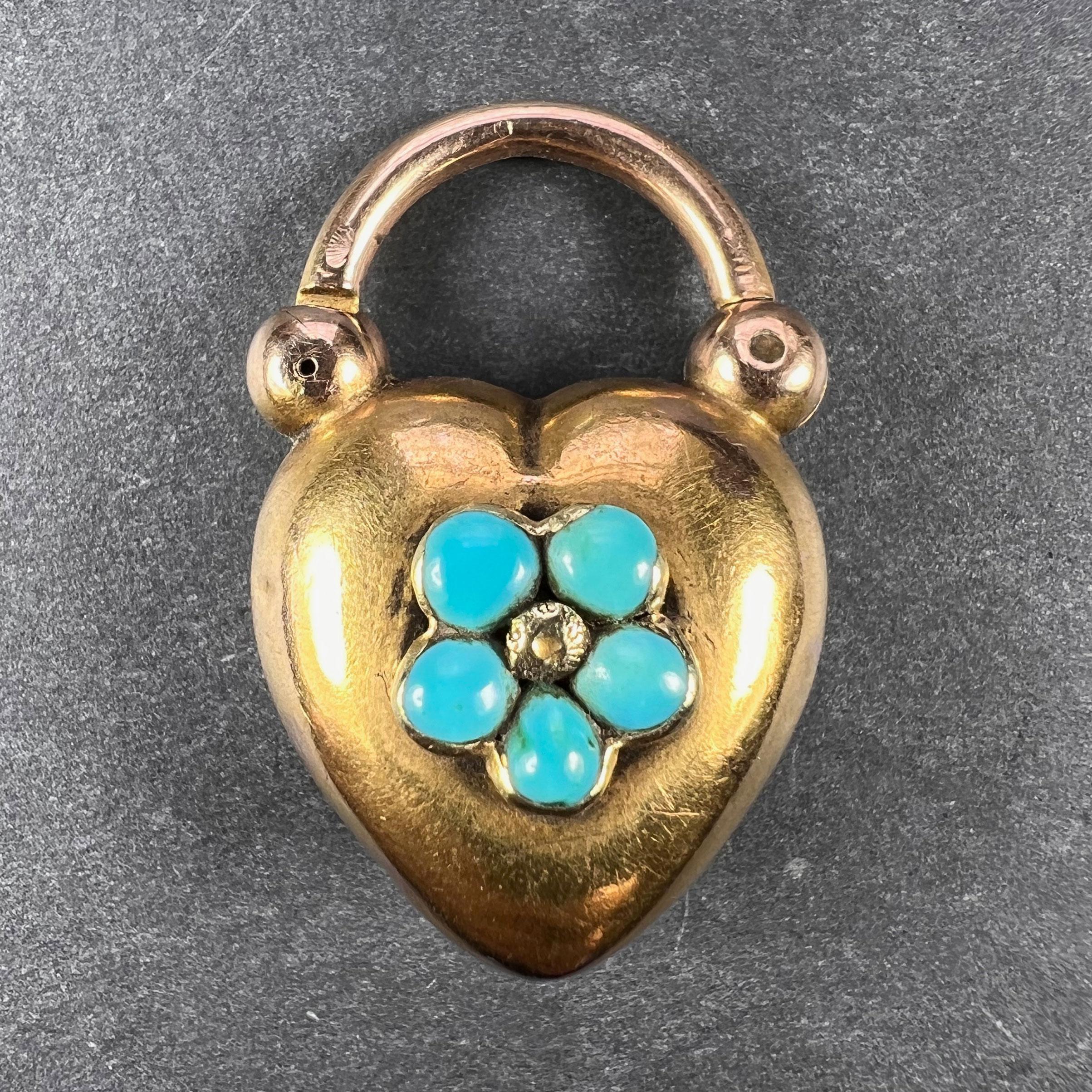 An Antique Victorian 15 karat (15K) yellow gold heart-shaped pendant mourning locket set with five turquoise cabochons in a flower design centring on a gold bead. The reverse set with a pear-shaped glass-fronted locket containing gold wire and other