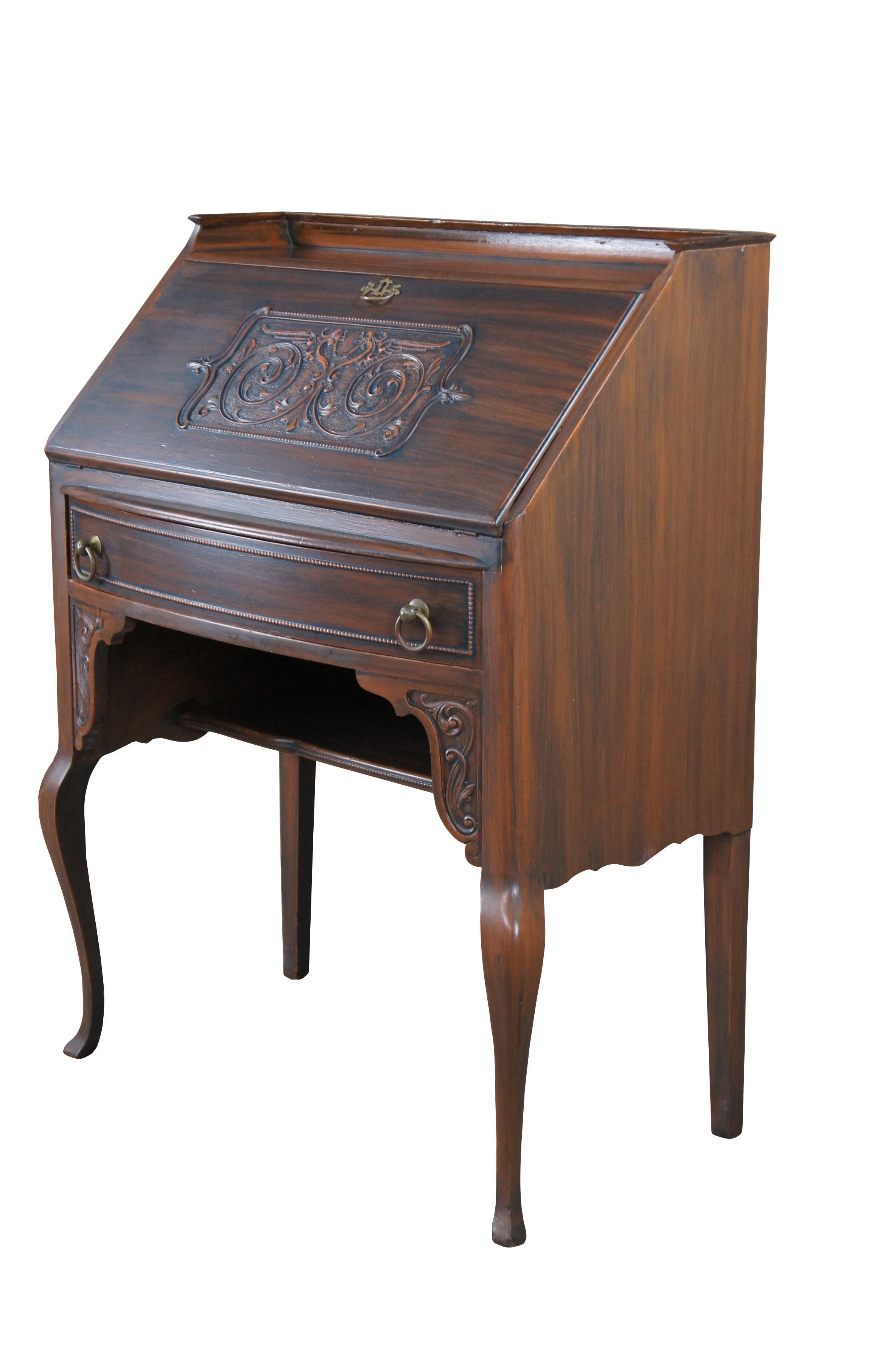 Antique Early 20th Century Victorian style secretary writing desk featuring painted grain finish and dragon / serpent / griffon carving.  The desk opens to large writing surface with multiple cubbies and compartments for storage; upper gallery,