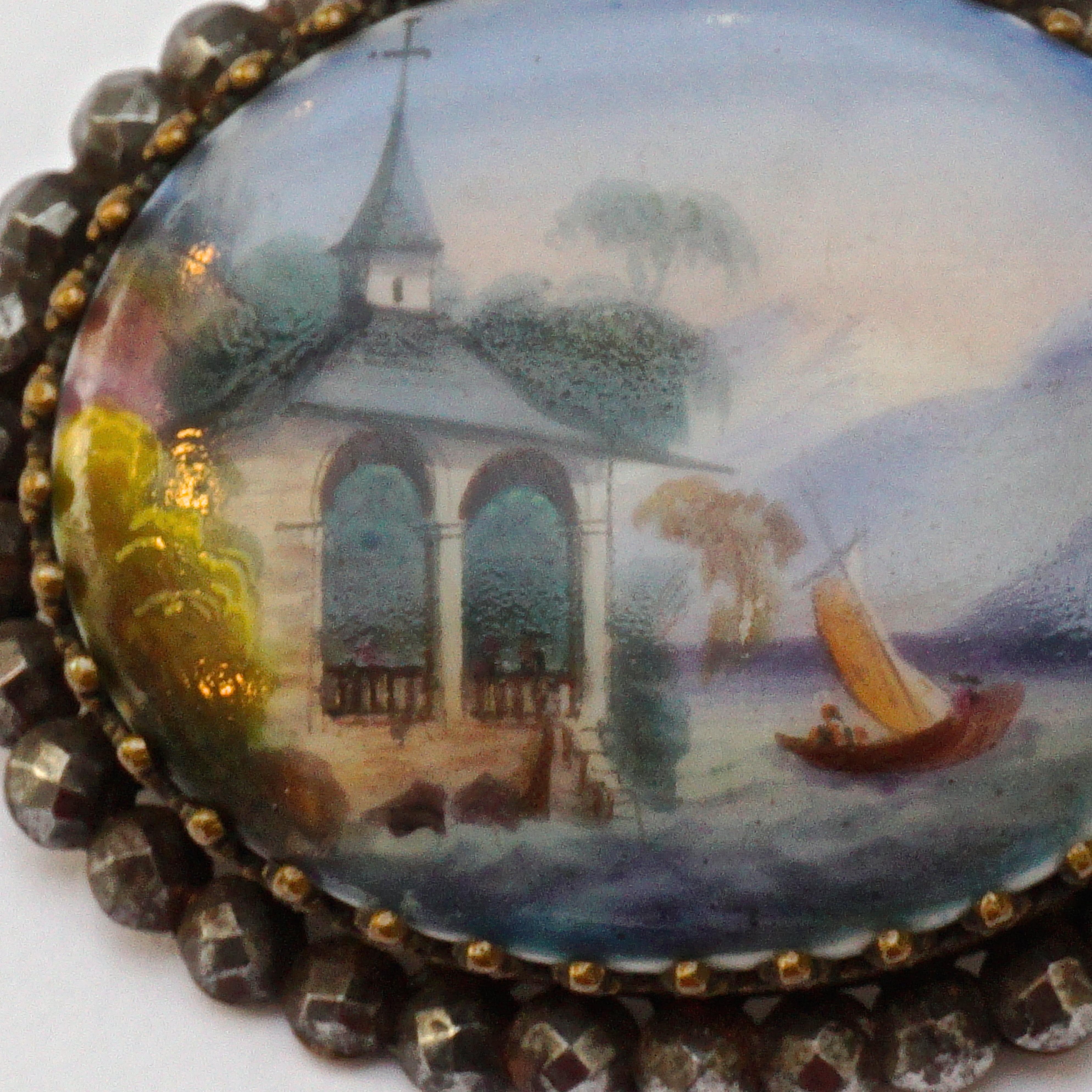 Antique Victorian painted porcelain brooch in an ornate setting with a cut steel edging. The beautiful painted picture is wonderfully detailed. Measuring length 4.1cm / 1.6 inches by width 3.5cm / 1.37 inches. It has the old 