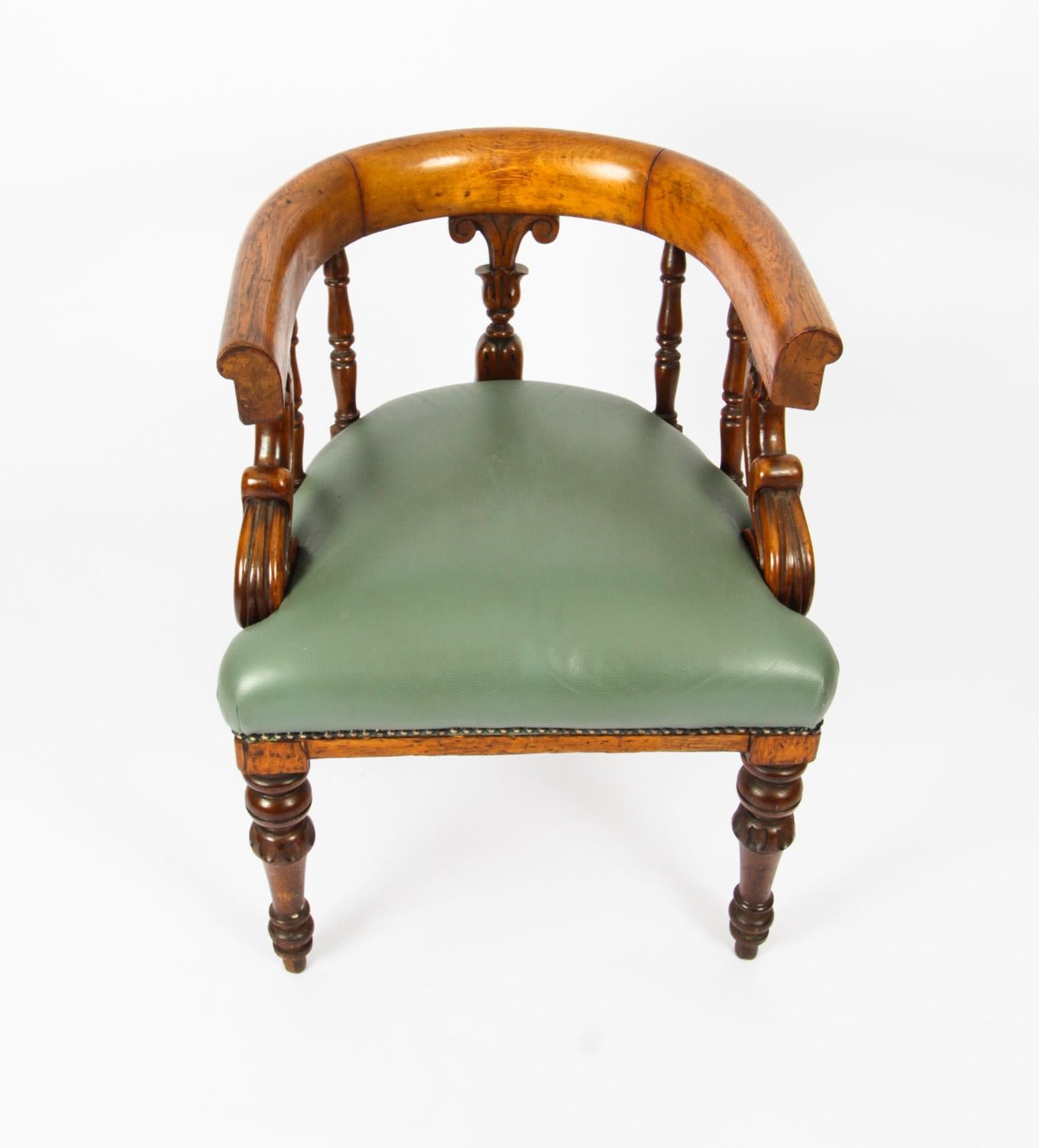 This is an absolutely fabulous pair of antique Victorian Mahogany library armchairs, circa 1860 in date.

The chairs have been recently reupholstered in close-nailed leather, one in red, the other in green and feature curved back supports above