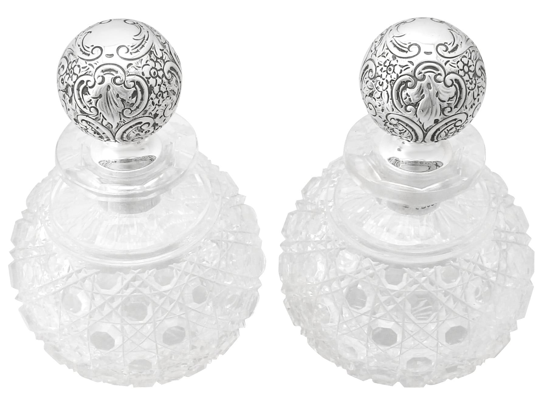 An exceptional, fine and impressive pair of large antique Victorian English sterling silver and cut-glass scent bottles; an addition to our silver mounted glass collection.

These exceptional antique Victorian cut-glass cologne bottles have a