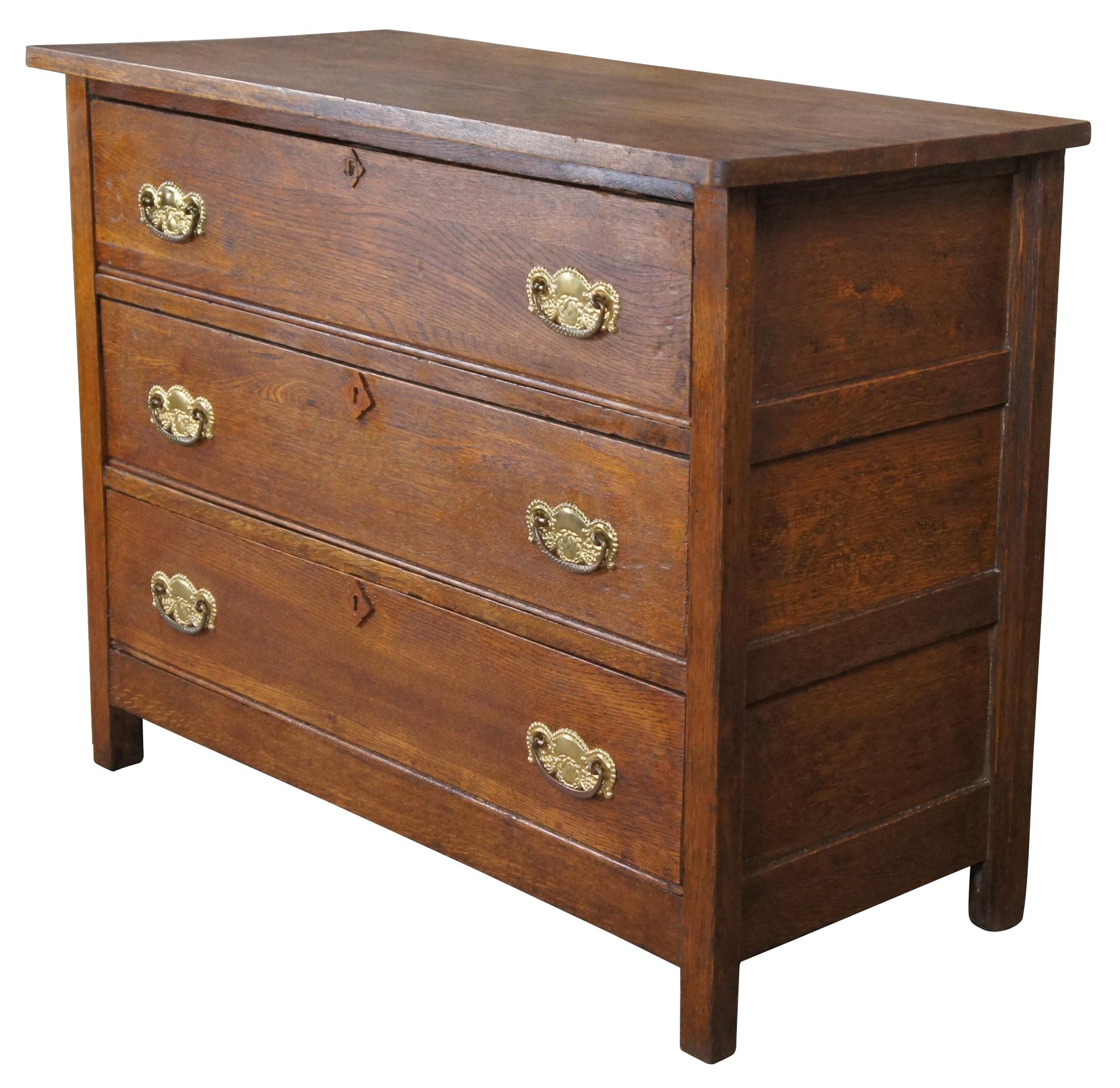 Antique late Victorian dresser or chest of drawers. Features three dovetailed drawers with ornate hardware, diamond raised escutcheons and paneled sides.