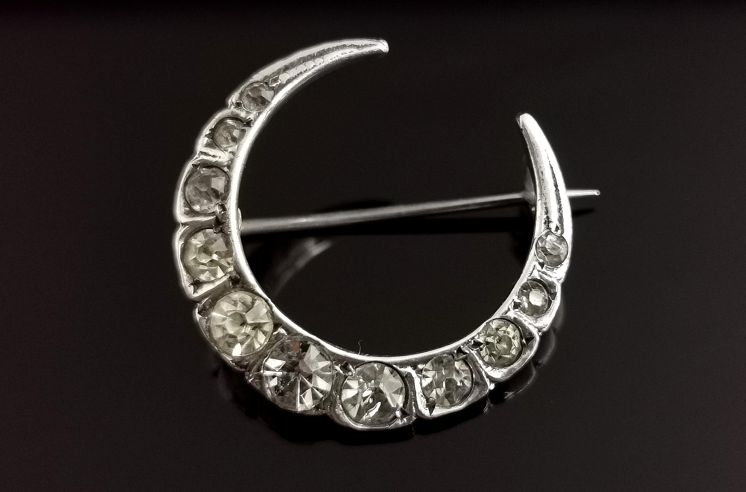 A very pretty late Victorian, silver and paste crescent brooch.

A beautiful curved moon set with pretty sparkling paste stones, resembling diamond with plenty of sparkle.

Paste jewellery despite being used as a low cost substitute for diamond on