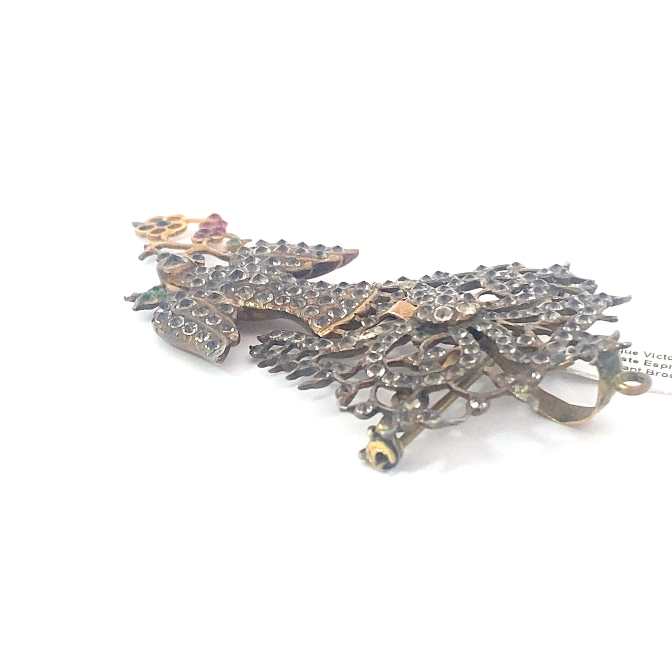 Deliciously Large brooch from the Victorian era. This piece is a full 3 inches of articulated splendor. Depicting a bird, this brooch features lovely past stone pave in a number of colors including clear, red, blue and green. This enormous piece