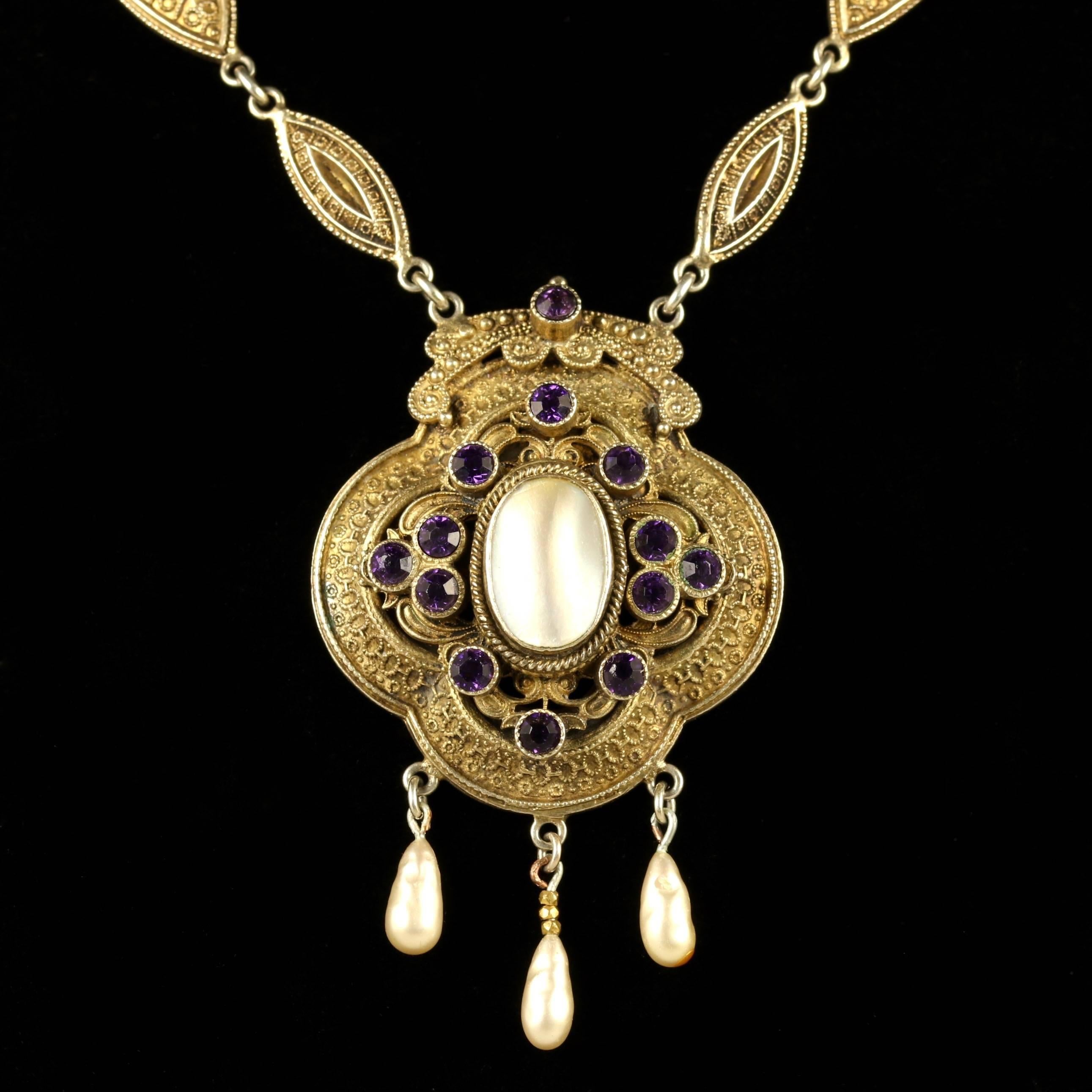 This outstanding Victorian Gold plated necklace is adorned with rich purple Paste stones and lustrous creamy Blister Pearls, Circa 1900.

This necklace is adorned with 3 fancy Blister Pearl droppers.

This boasts gorgeous Purple Paste stones in a
