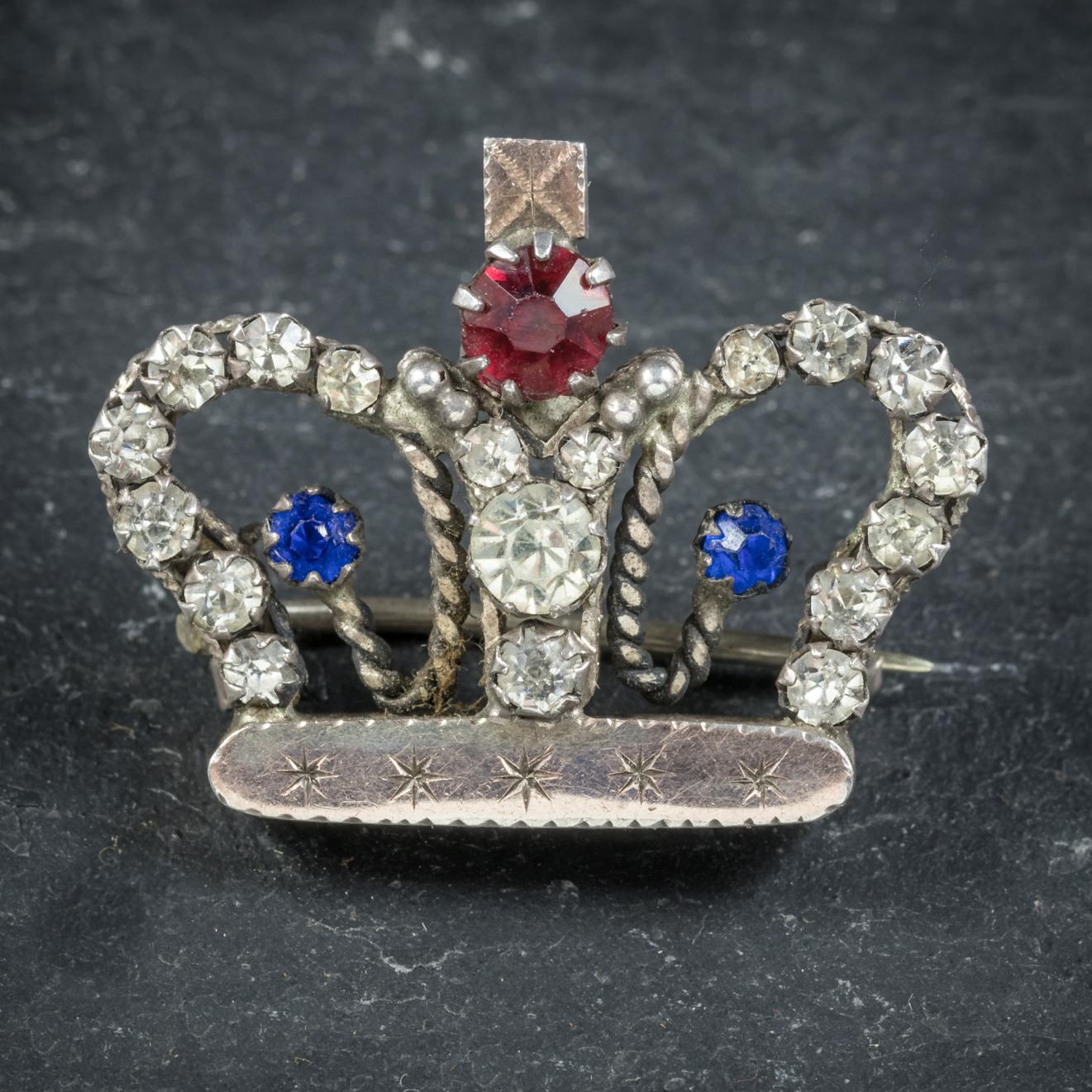 This delightful antique crown brooch is Victorian, Circa 1900.

The fabulous little crown is adorned with bright red, white and blue Paste Stones that simulate Rubies, Sapphires and Diamonds.

Beautifully made from white Metal and Silver with a Gold