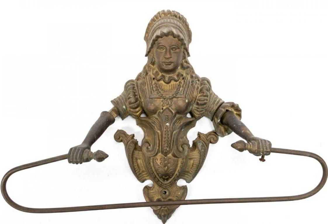 A rare original cast gilt-brass figural wall mount kitchen or bathroom towel holder. The charming Victorian antique depicting a lovely woman (possibly milkmaid) in period dress above a brass crest, with a towel bar affixed to the woman’s hands. One