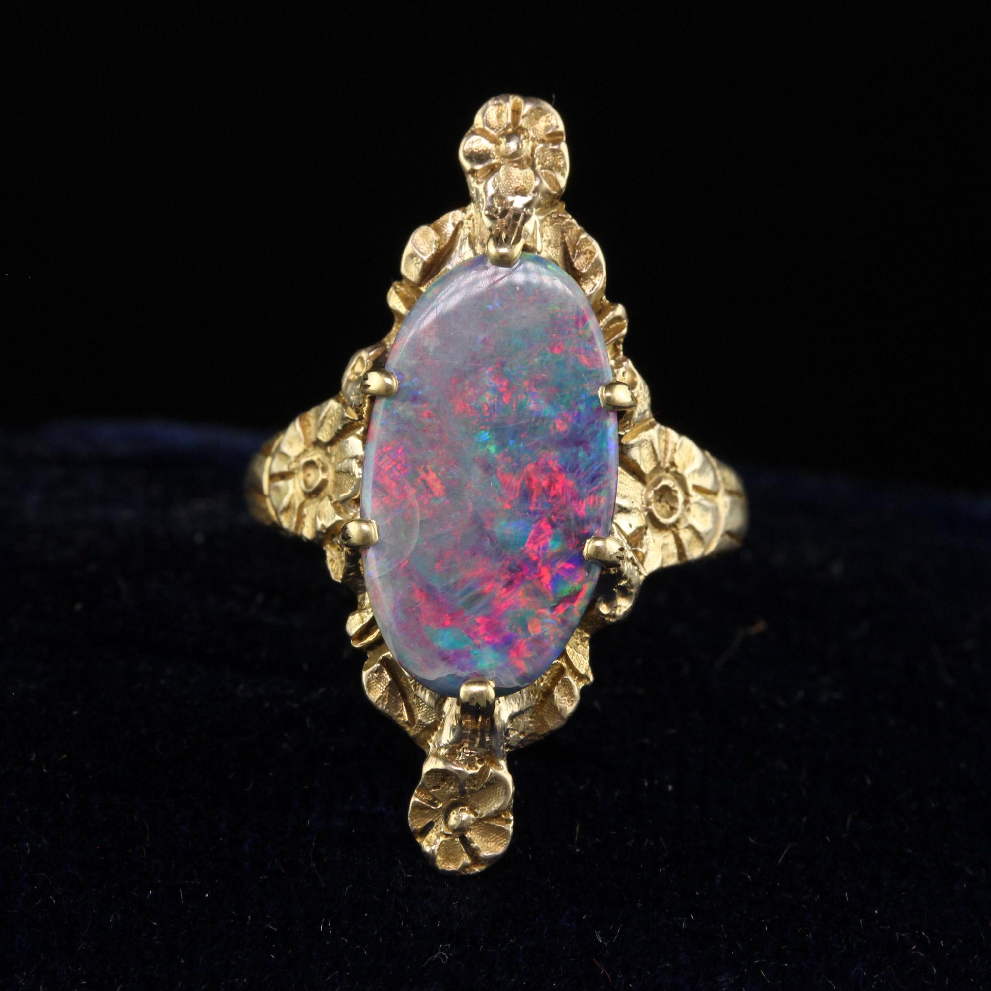 Beautiful Antique Victorian Peacock 10K Yellow Gold Boulder Opal Floral Ring. This beautiful Victorian ring is crafted in 10k yellow gold. The center holds a gorgeous opal that has flashes of red, blue, and green. The ring is in good condition and