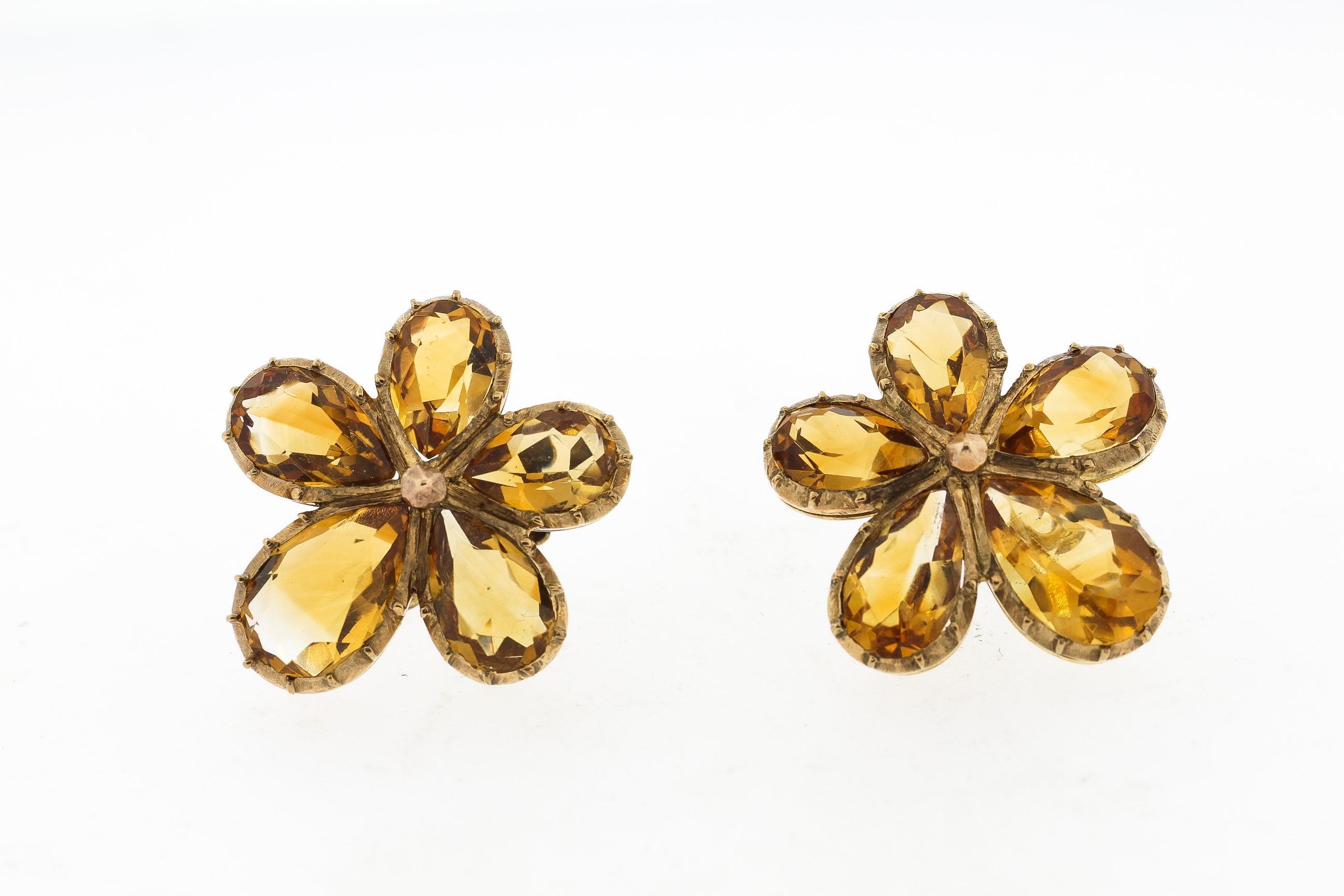 Antique 9k yellow gold earrings set with 5 pear shape vitrines two form a pansy shaped flower. The yellow of the citrine is bright. The earring backs are stamped 9k and are screw backs. They can be easily converted to hang from a wire. The earrings