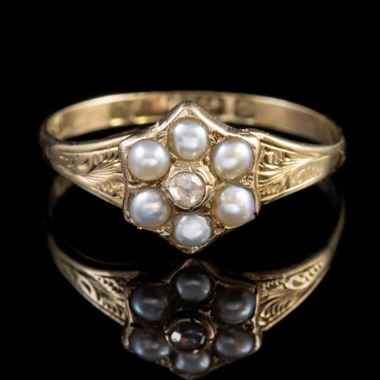 This beautiful ring has been modelled in 9ct Yellow Gold and features six gorgeous Pearls which halo a central sparkling old cut Diamond weighing approx. 0.10ct. The ring features lovely old engraved shoulders and also comes with a locket back. The