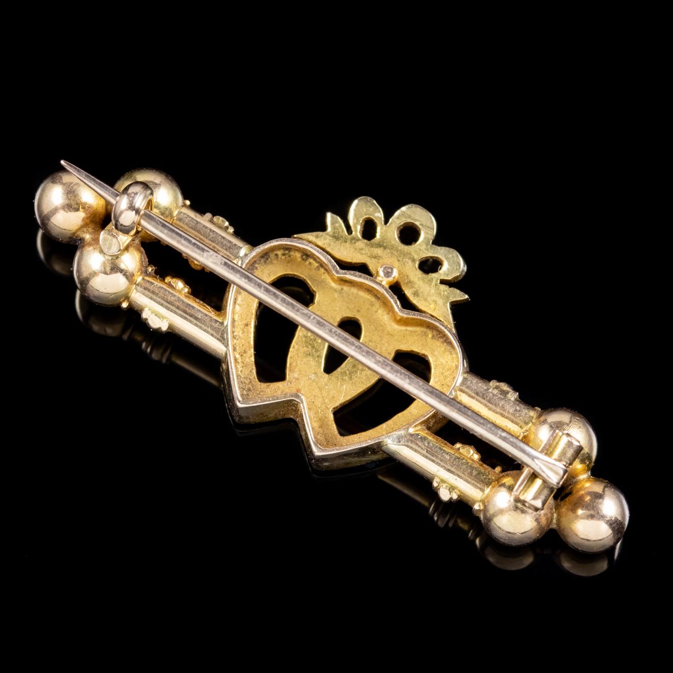A lovely antique brooch from the Victorian era featuring a bow crowned on top of two entwined hearts which symbolize a loving eternal bond. 

Pearls are a true gift from Mother Nature and symbolize purity innocence and beauty which is why they are a