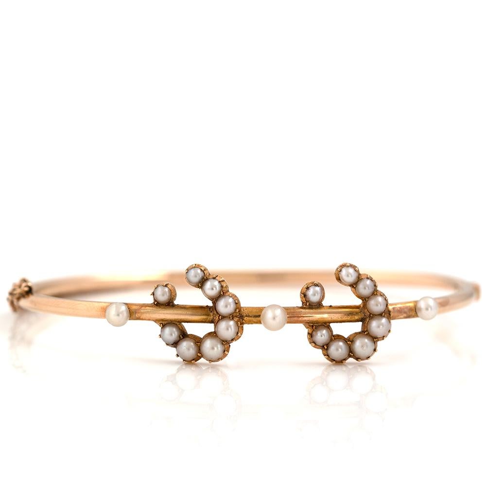 Our Antique Victorian Horseshoe bangle features bright white pearls set into a warm 15ct gold setting. This timeless piece features two pearl horseshoes, a symbol of Good Luck and Protection, the horseshoe became popular in the Victorian era in