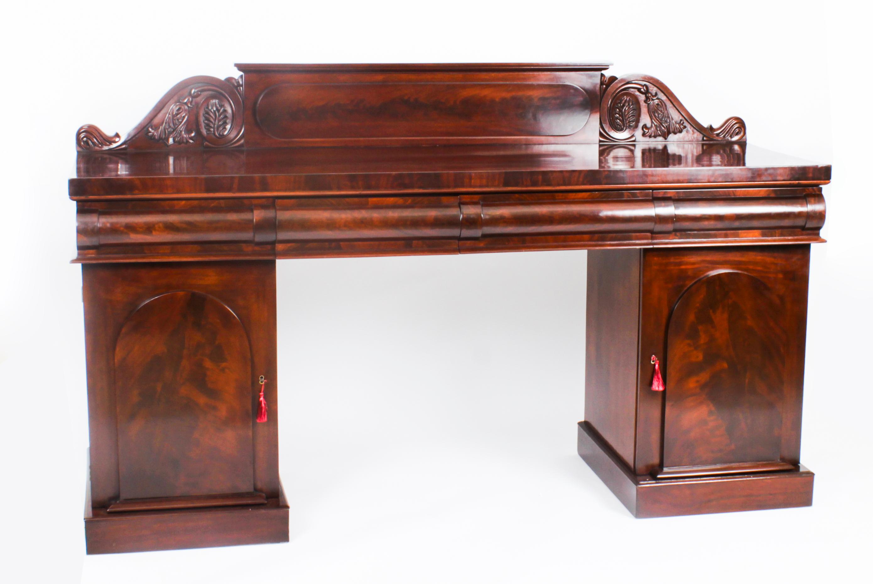 This is a superb antique early Victorian flame mahogany architectural twin pedestal sideboard, circa 1850 in date.
 
The rectangular top having a thumb moulded edge above four drawers that are outlined in bobbin and reel mouldings.
 
Raised on twin