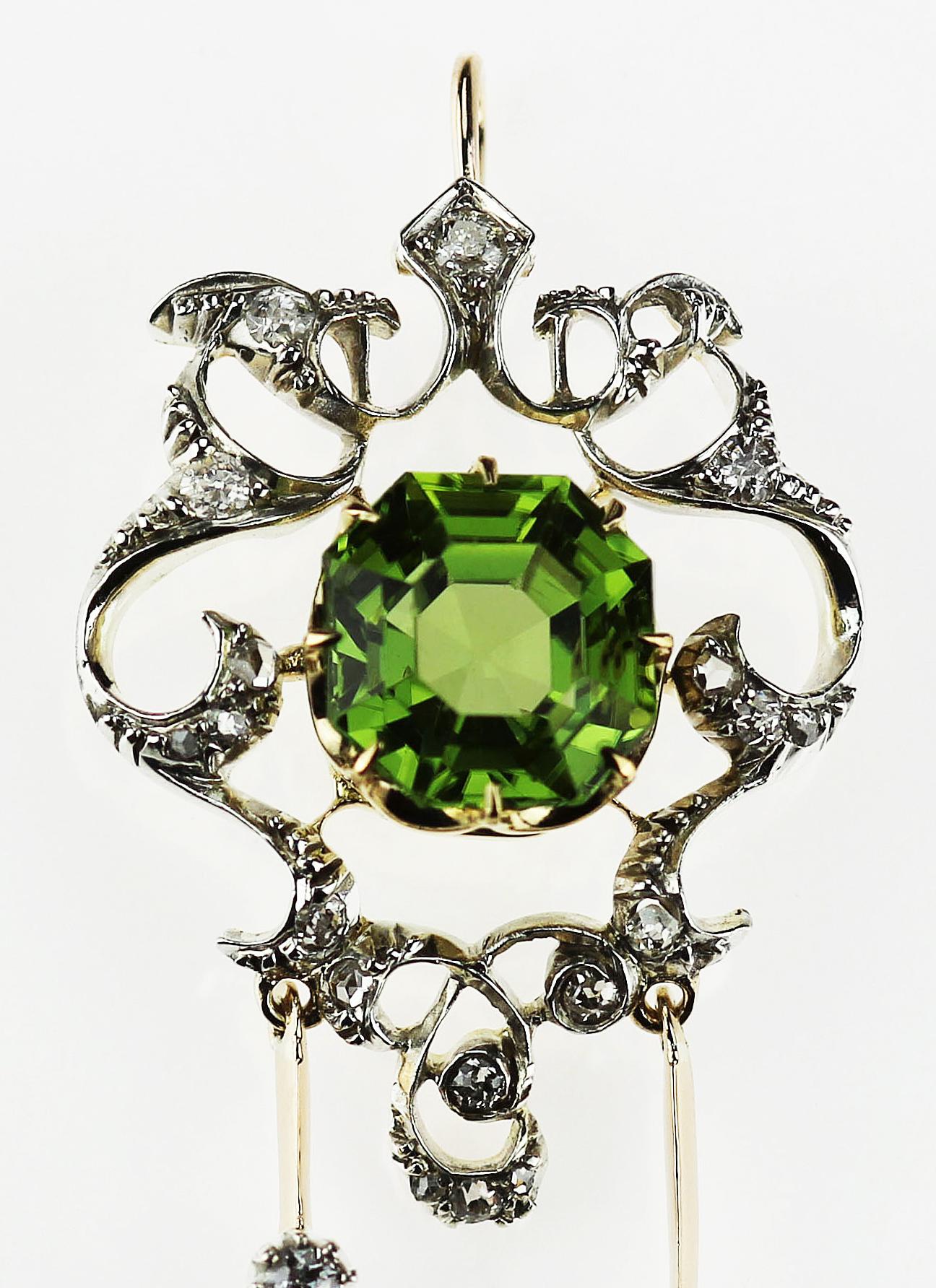 Antique, Victorian  Peridot and diamond pendant/brooch set in 18K yellow gold and silver, with detachable brooch fitting.
1 x Cut corner rectangular Peridot, approximate weight 3.3 carats
19 x Old European and Rose cut diamonds, approximate total