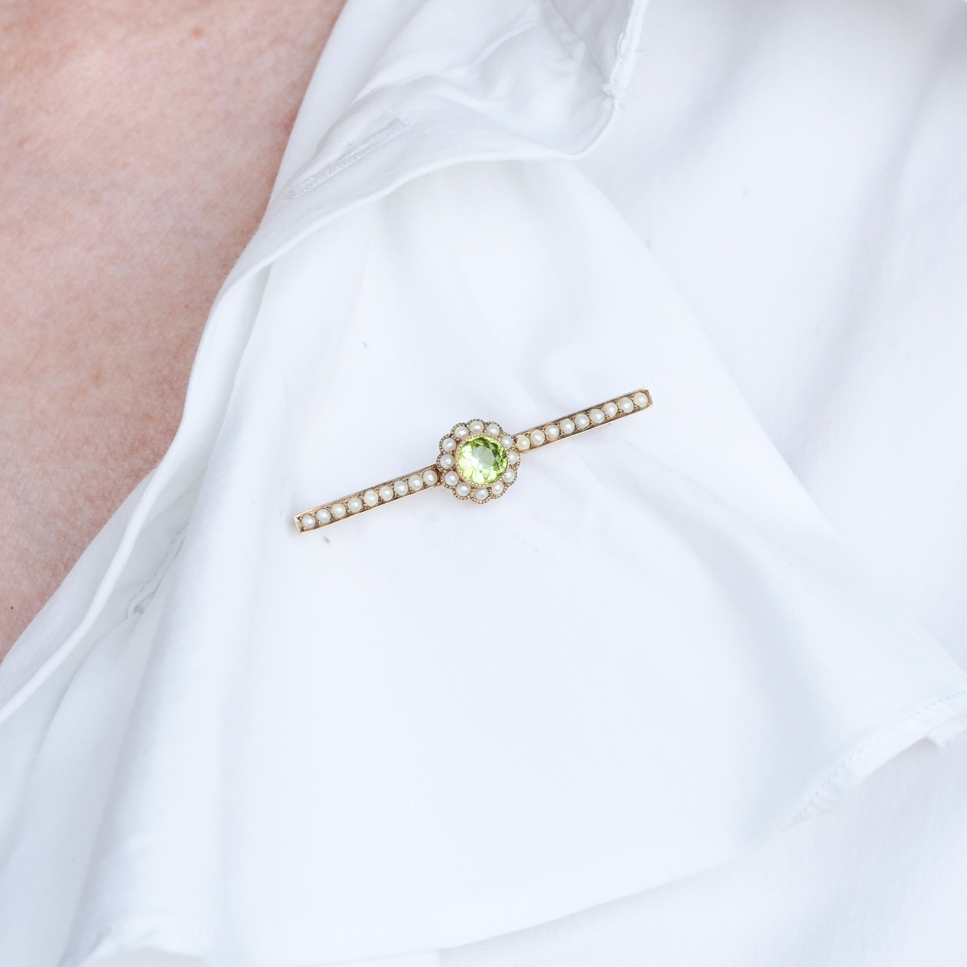 We are delighted to offer this beautiful antique 9ct gold peridot and seed pearl cluster brooch, made c.1900. 

This endearing brooch features a single round faceted peridot in the middle which has a wonderful green hue somewhere between a lime