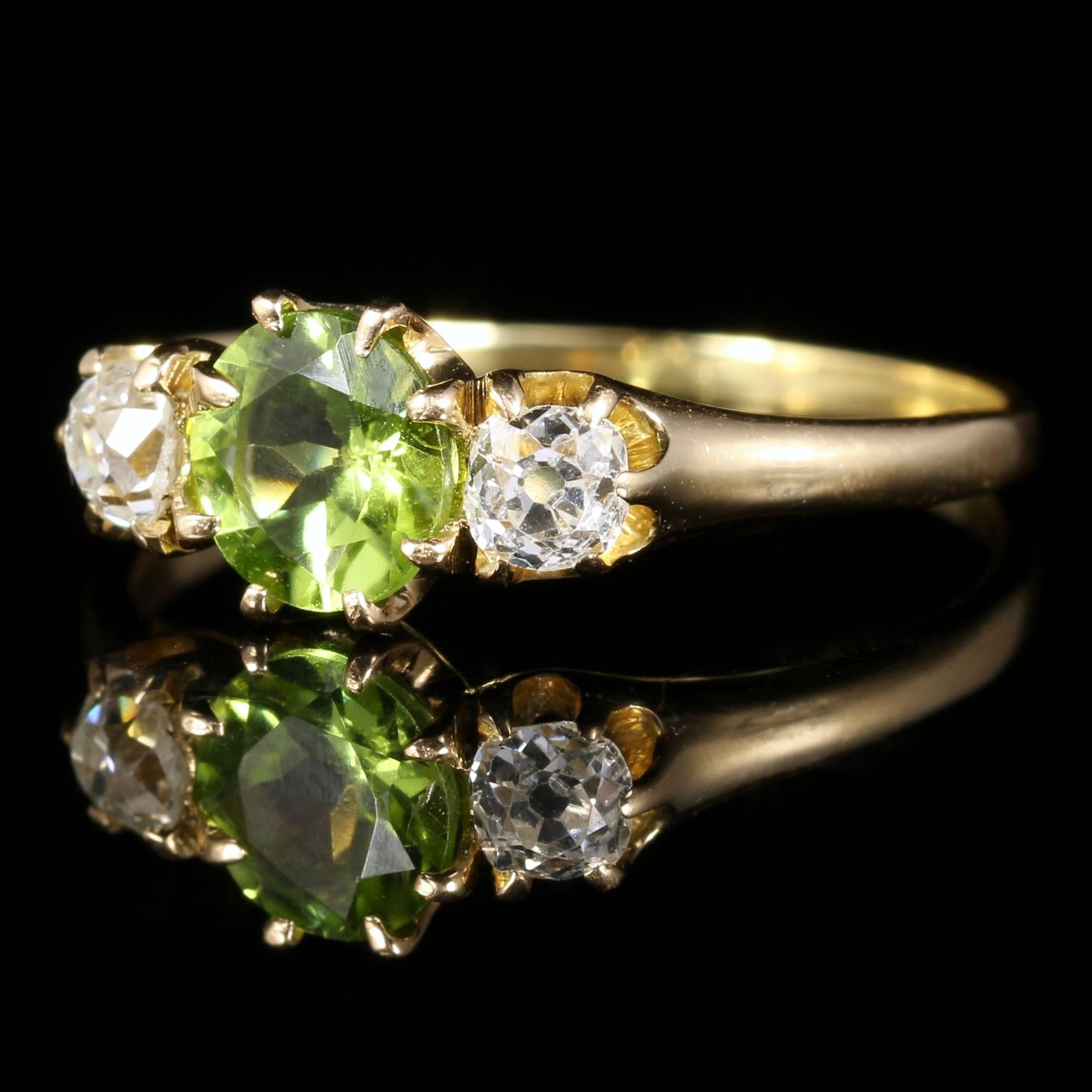 For more details please click continue reading down below...

This fabulous antique Victorian Peridot and Diamond trilogy ring is set in 18ct Gold. Circa 1890

The central Peridot is approx 0.85ct ins size, each Diamond is 0.15ct in size.

Each