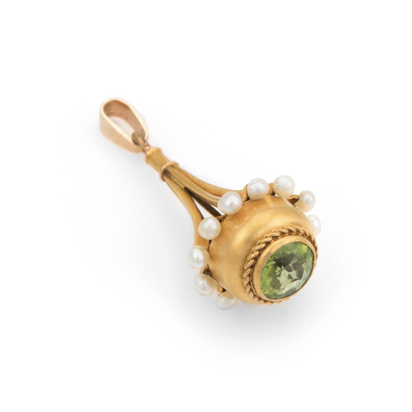 Finely detailed antique Victorian era (circa 1880s to 1900s) pendant or fob, crafted in 18 karat yellow gold. 

The pendant is set with a 6mm round faceted peridot (estimated at 1 carat), accented with 12 x 2mm seed pearls. The seed pearls are