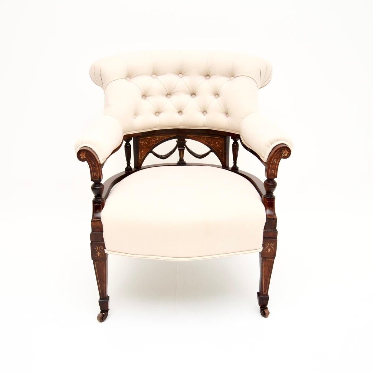 A gorgeous antique Victorian armchair. This was made in England, it dates from around the 1880-1900 period.

It is of outstanding quality, it is a lovely size and is very comfortable. The frame has beautiful inlays of various woods, sitting on
