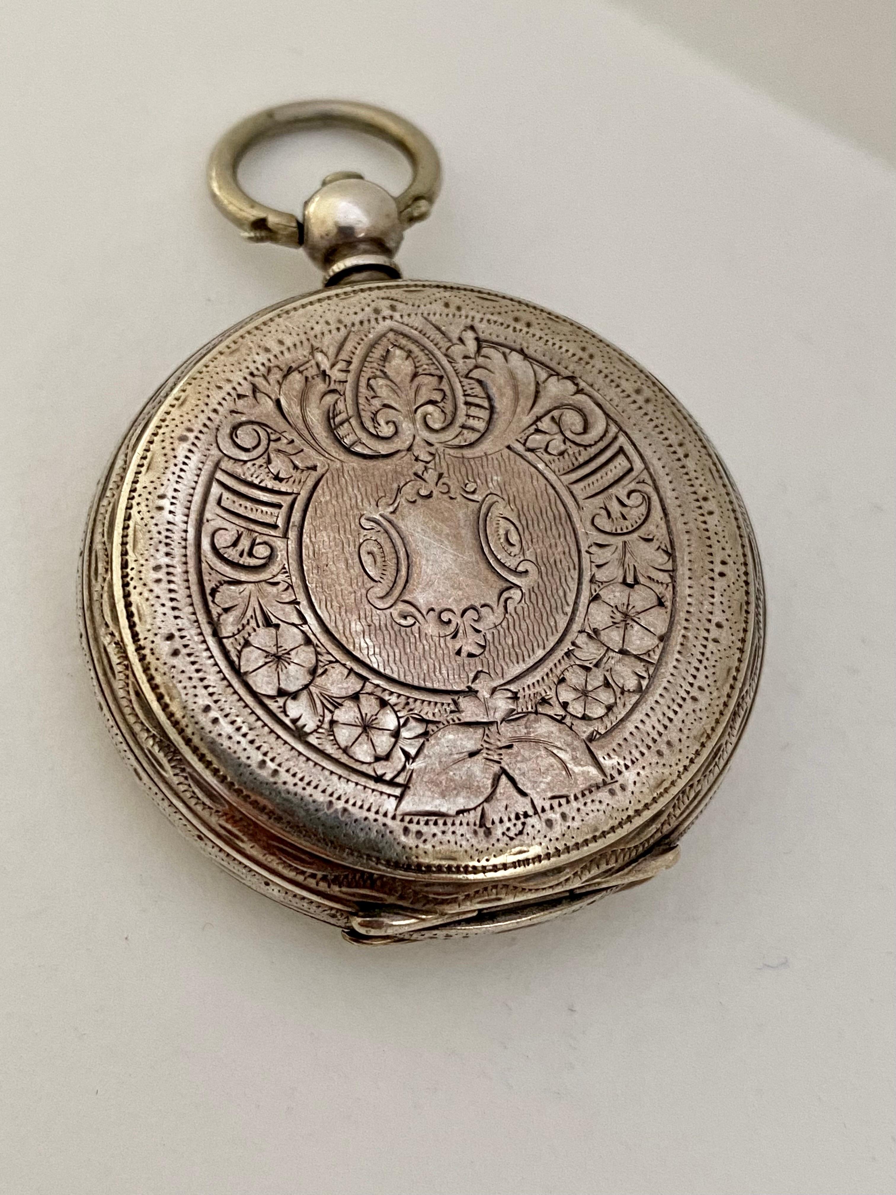 This beautiful 38mm diameter (excluding crown) key winding silver pocket / fob watch is in good working condition and it is running well. Visible signs of ageing and wear with tiny and light surface marks on the glass and on the watch case. It comes