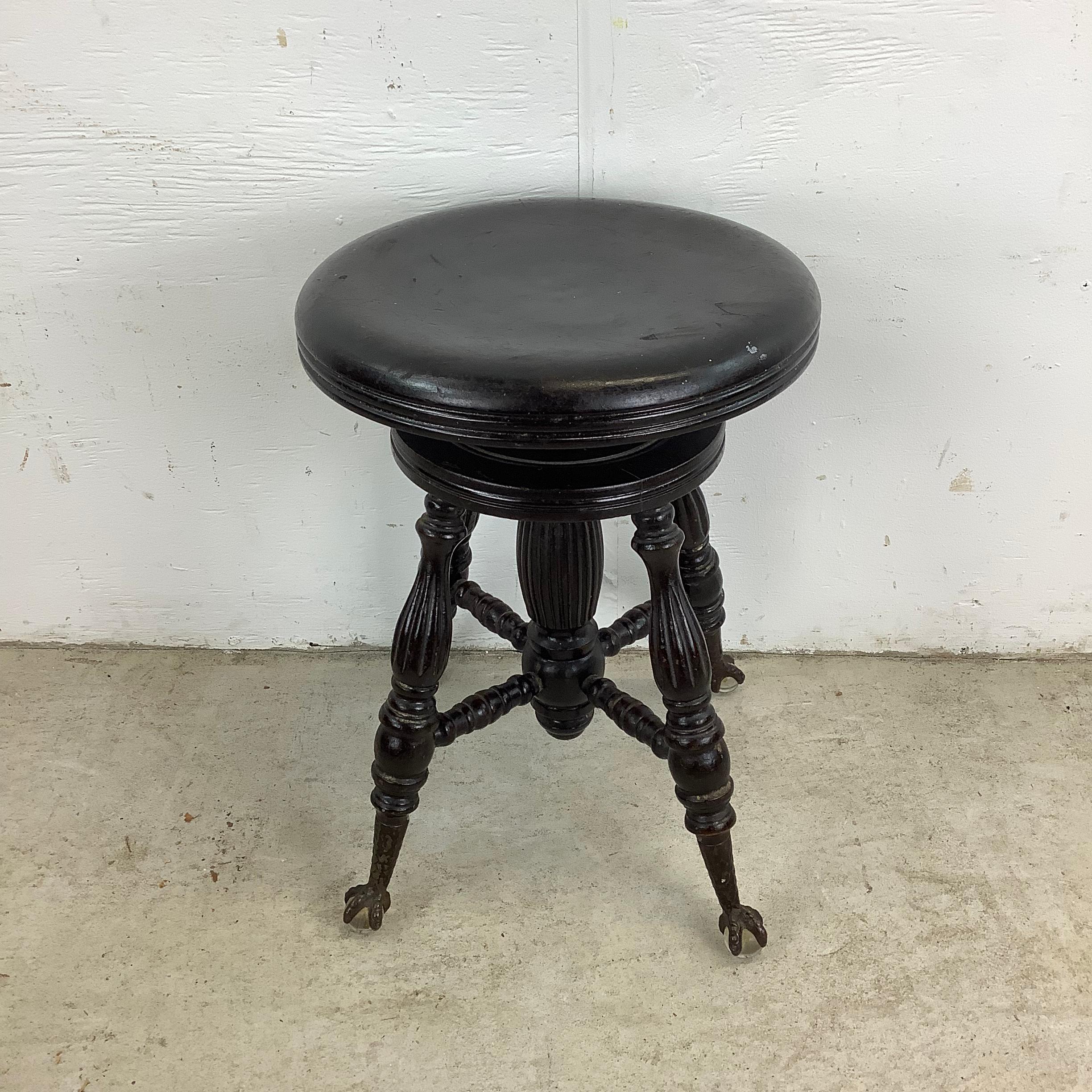 This antique Victorian piano stool or vanity stool is a truly exceptional piece that brings a touch of old-world charm to any room. Featuring beautifully crafted metal claw feet with glass ball accents, this stool embodies the elegance and
