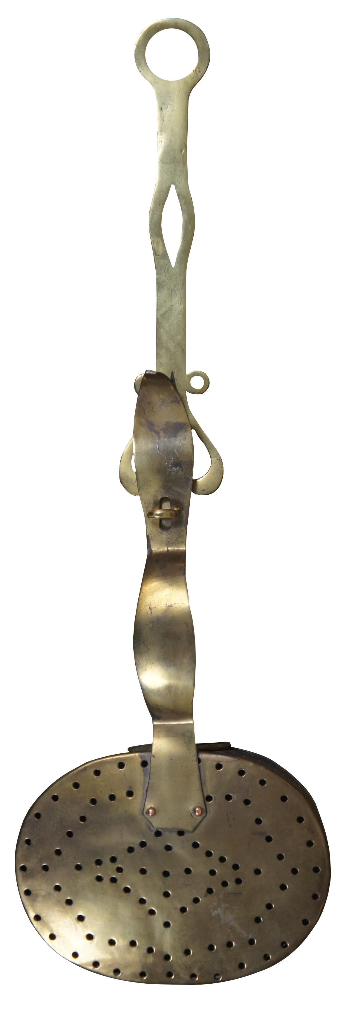 Antique Victorian Pierced Brass chestnut roasting pan.  Ornately designed with a locking lid mechanism and handle for hanging.
     
