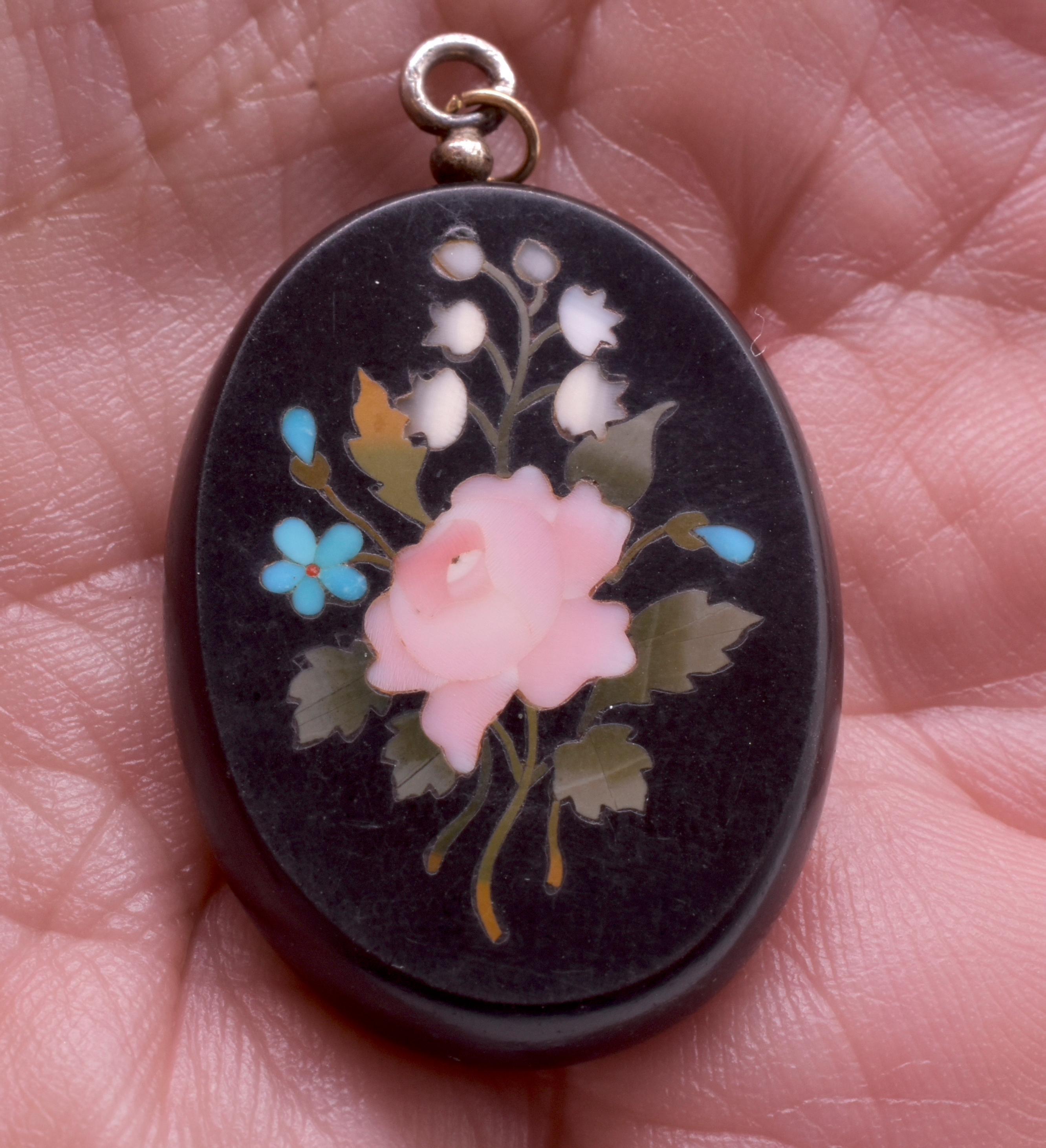 This is a lovely Victorian Pietra Dura locket pendant with its original 15K locket back.  Pietra Dura, otherwise known as Italian mosaic, is an art form utilizing Inlaid hard stones such as marble, agate, and turquoise to form a floral design. This
