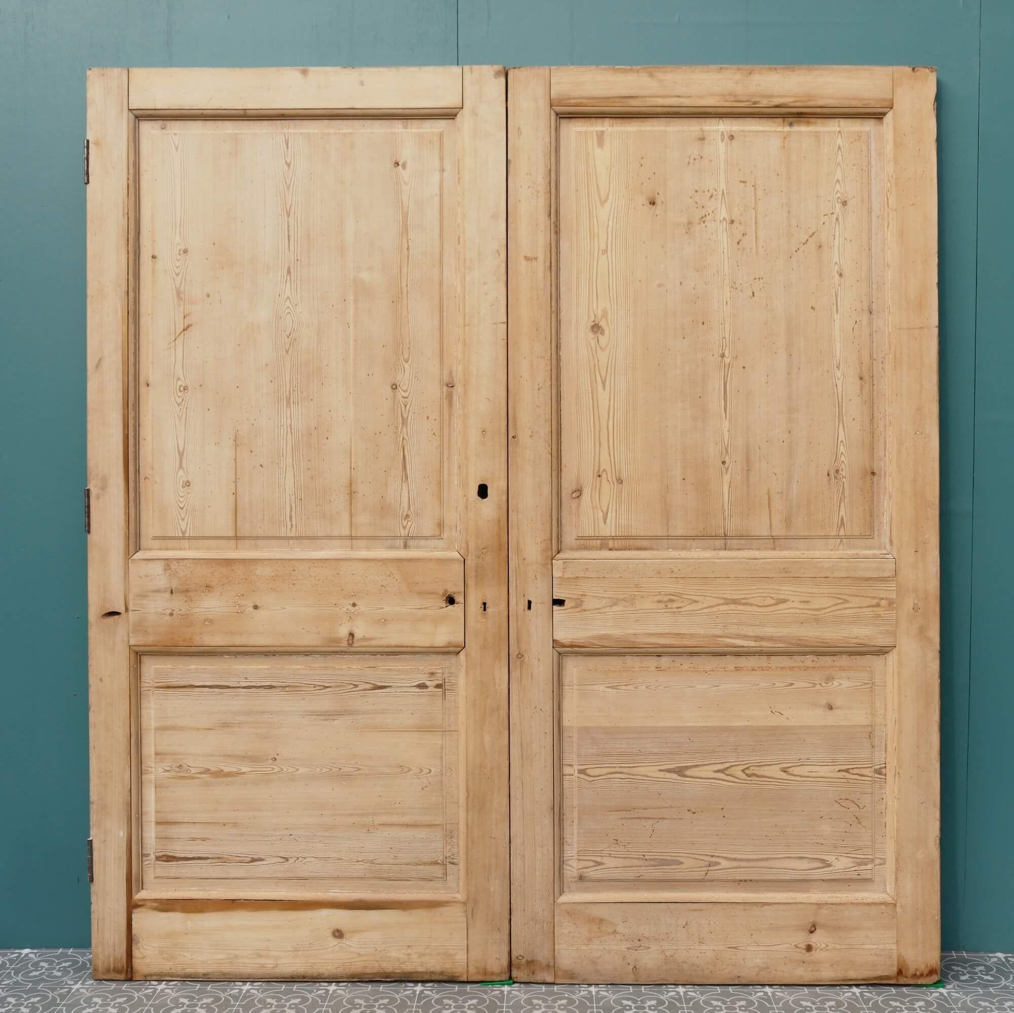 A pair of antique Victorian pine internal double doors dating from the early 20th century. These reclaimed double doors make a handsome set of dividing doors in a period townhouse or traditional cottage. Detailed with smart raised and fielded panels