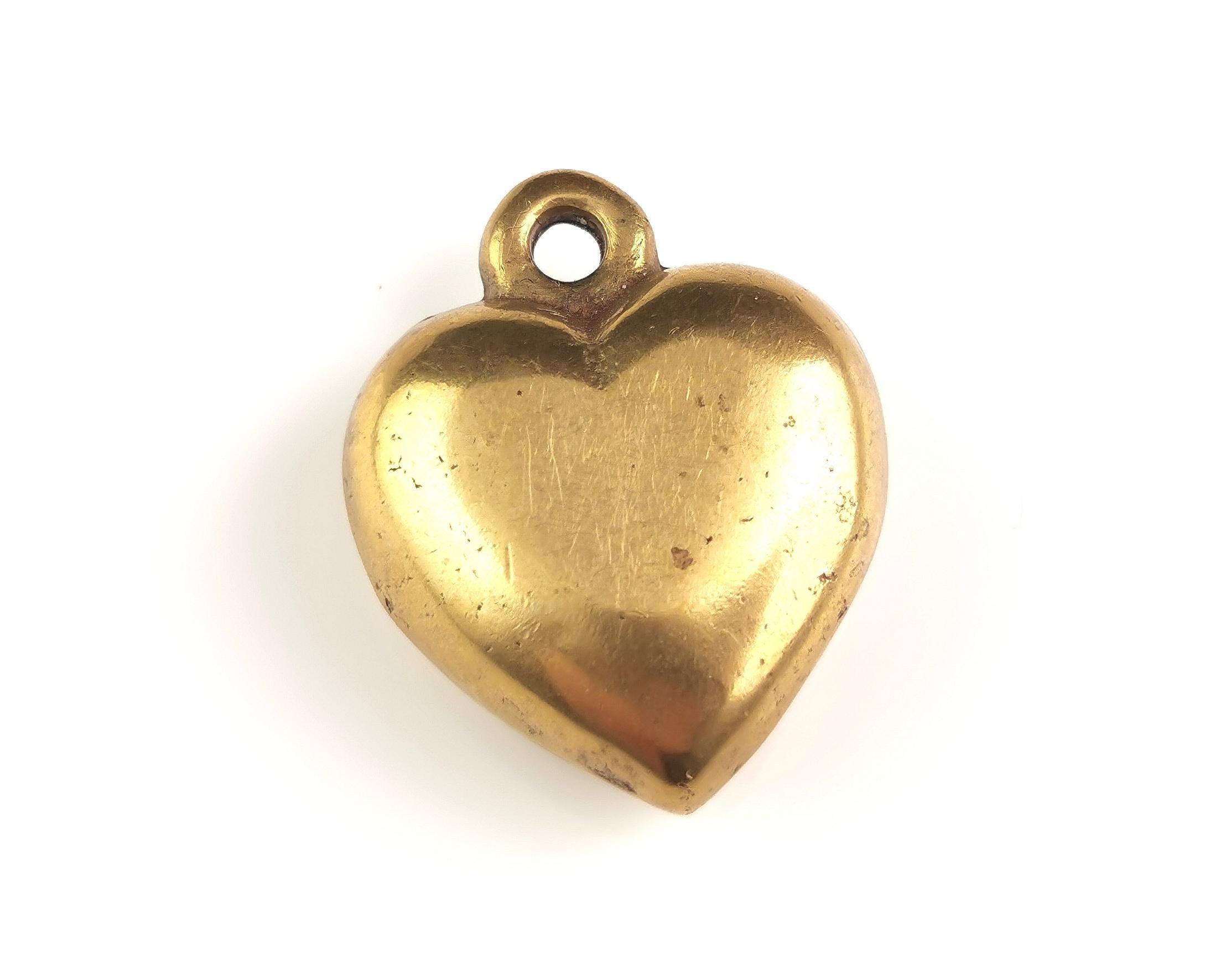 The sweetest antique Victorian era solid and chunky brass puffy heart pendant.

It is a solid piece so for its size it is really heavy.

It has that lovely chunky design and the nice aged patina of Antique brass.

No marks.

C1890s, English make,