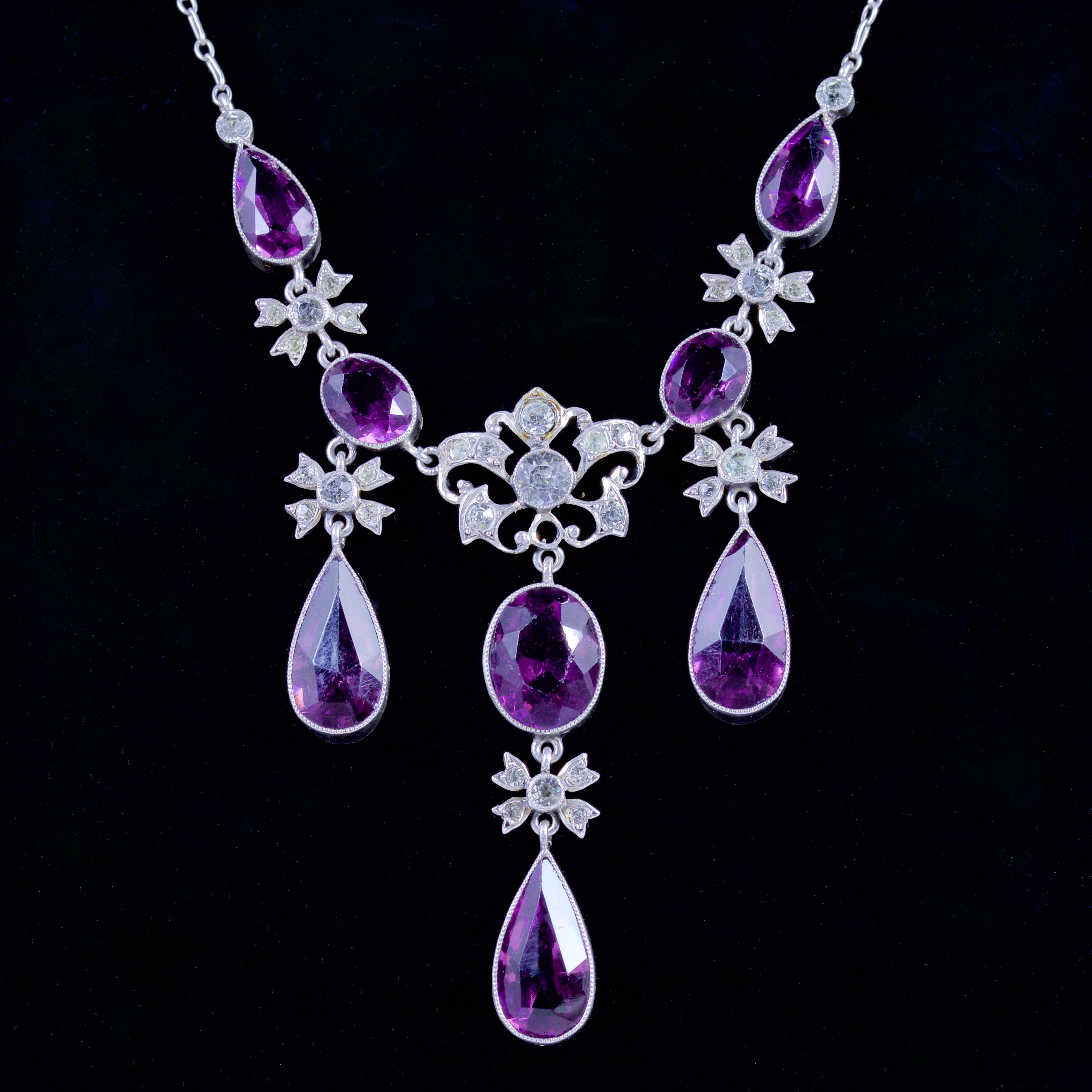 This spectacular Victorian necklace is set with Purple and White Paste Stones, Circa 1900.

The Paste Stones cascade down the necklace leading to a beautiful white Paste Stone gallery and purple Paste Stone droppers.

The necklace is set in Silver