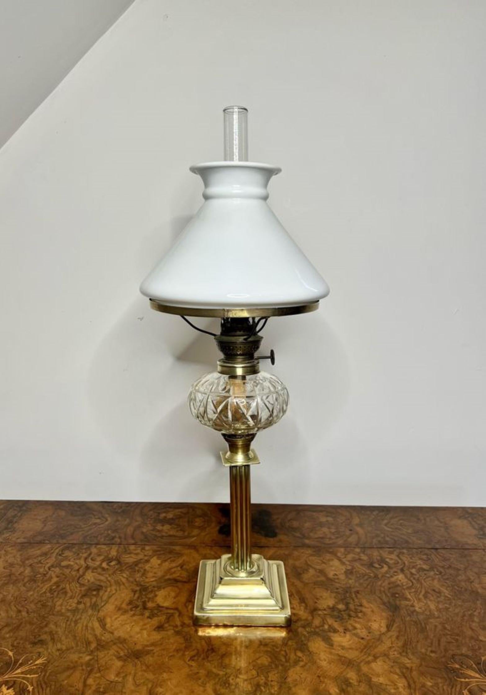 Antique Victorian quality brass and cut glass oil lamp, having the original white glass shade and chimney, a single brass burner with a quality cut glass font, supported on a brass reeded column standing on a square stepped brass base. 

D. 1860