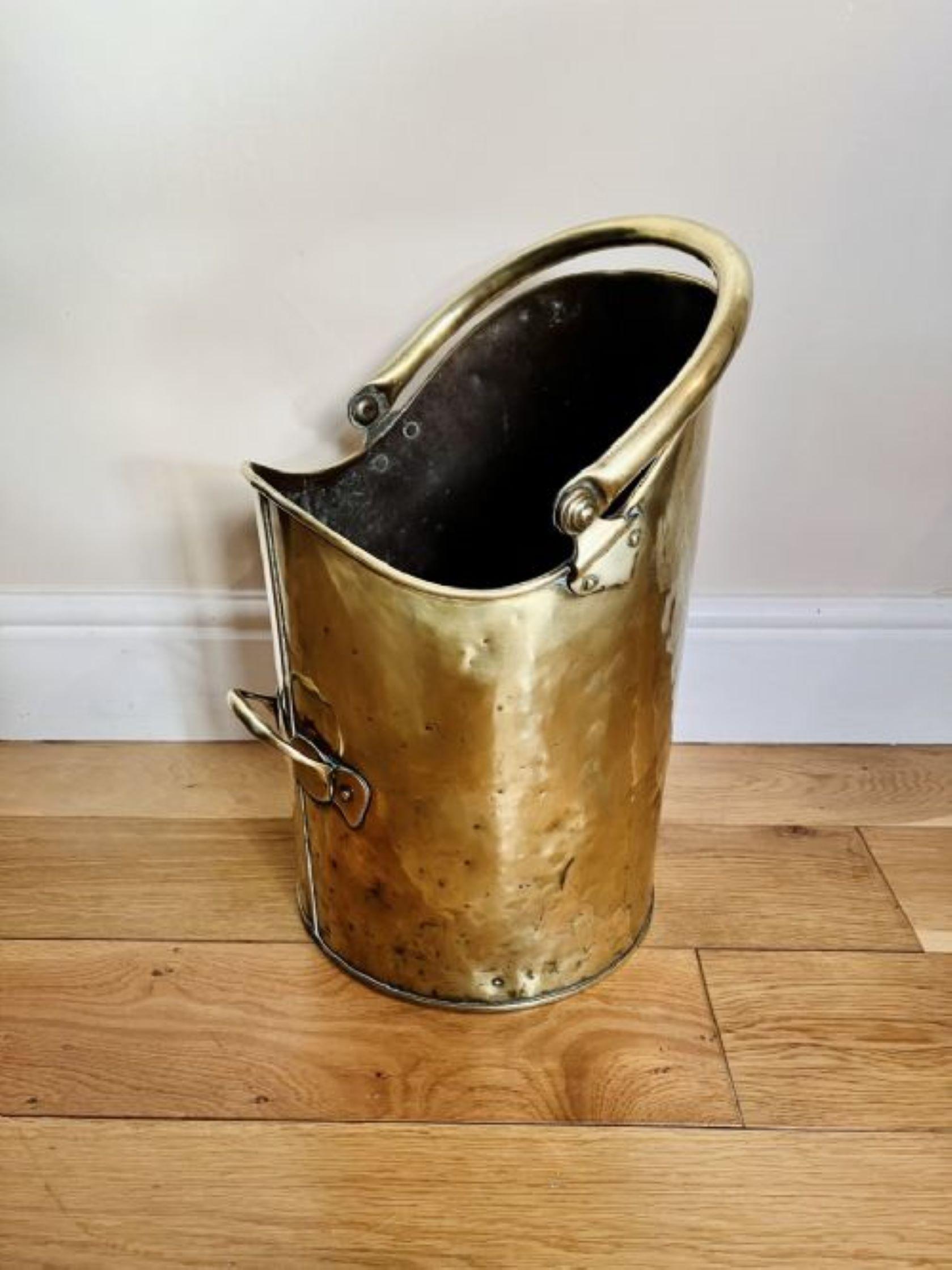 Antique Victorian quality brass coal scuttle having a quality swing carrying handle to the top and a shaped brass handle to the side