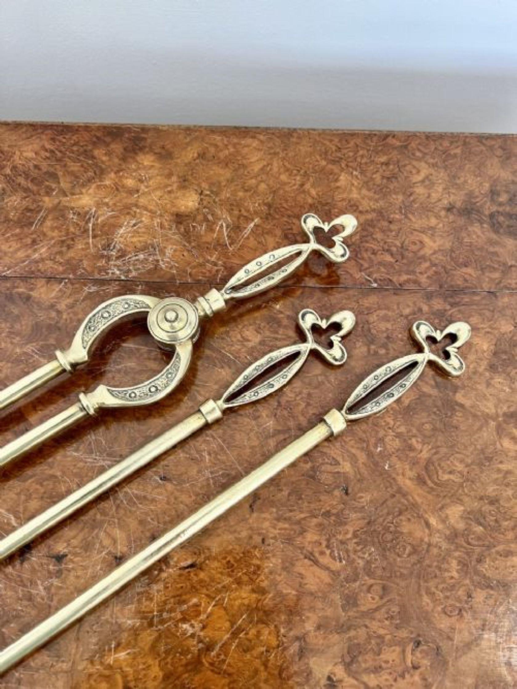 Antique Victorian quality brass fire irons and fire dogs having a quality set of antique Victorian fire irons consisting of a shovel, fire poker and fire tongs with a pair of original ornate fire dogs 