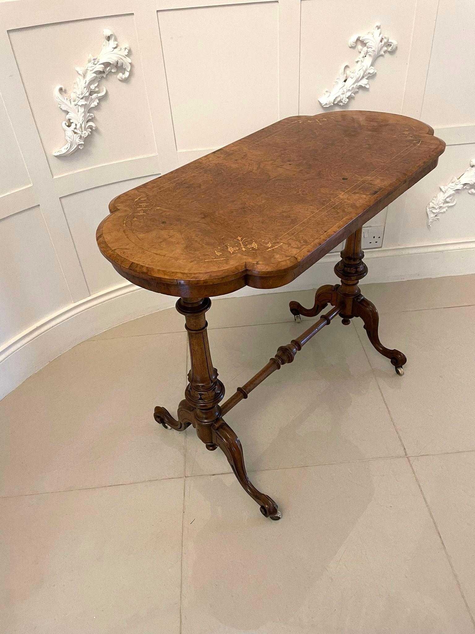 Antique Victorian quality burr walnut inlaid freestanding centre table having a quality attractive inlaid burr walnut shaped top and a moulded edge, shaped frieze supported by two turned carved shaped solid walnut columns standing on four shaped