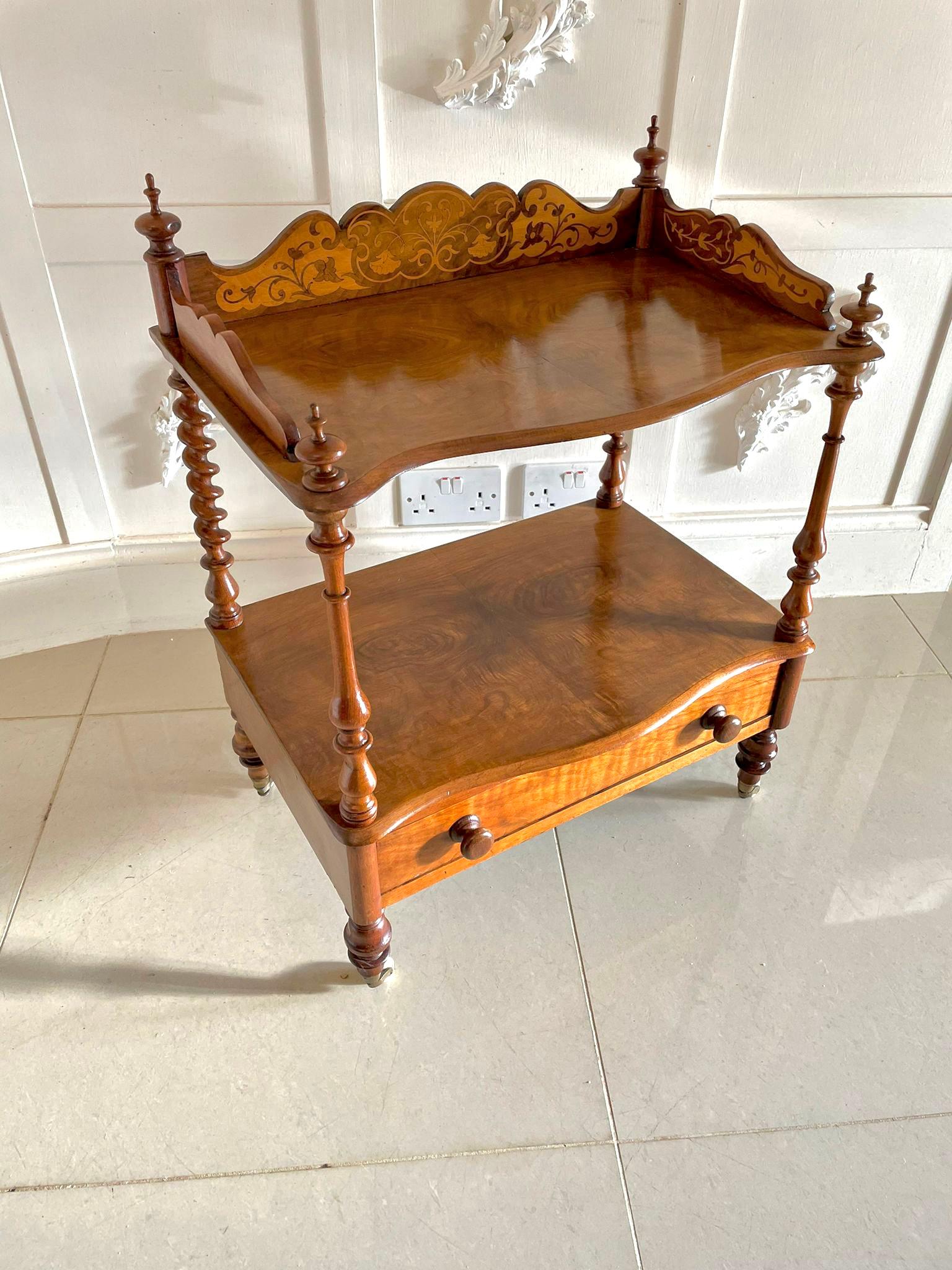 Antique Victorian quality burr walnut inlaid lamp table having a quality pretty marquetry inlaid shaped gallery back with four original turned walnut finals above two burr walnut serpentine shaped shelves supported by solid walnut turned shaped