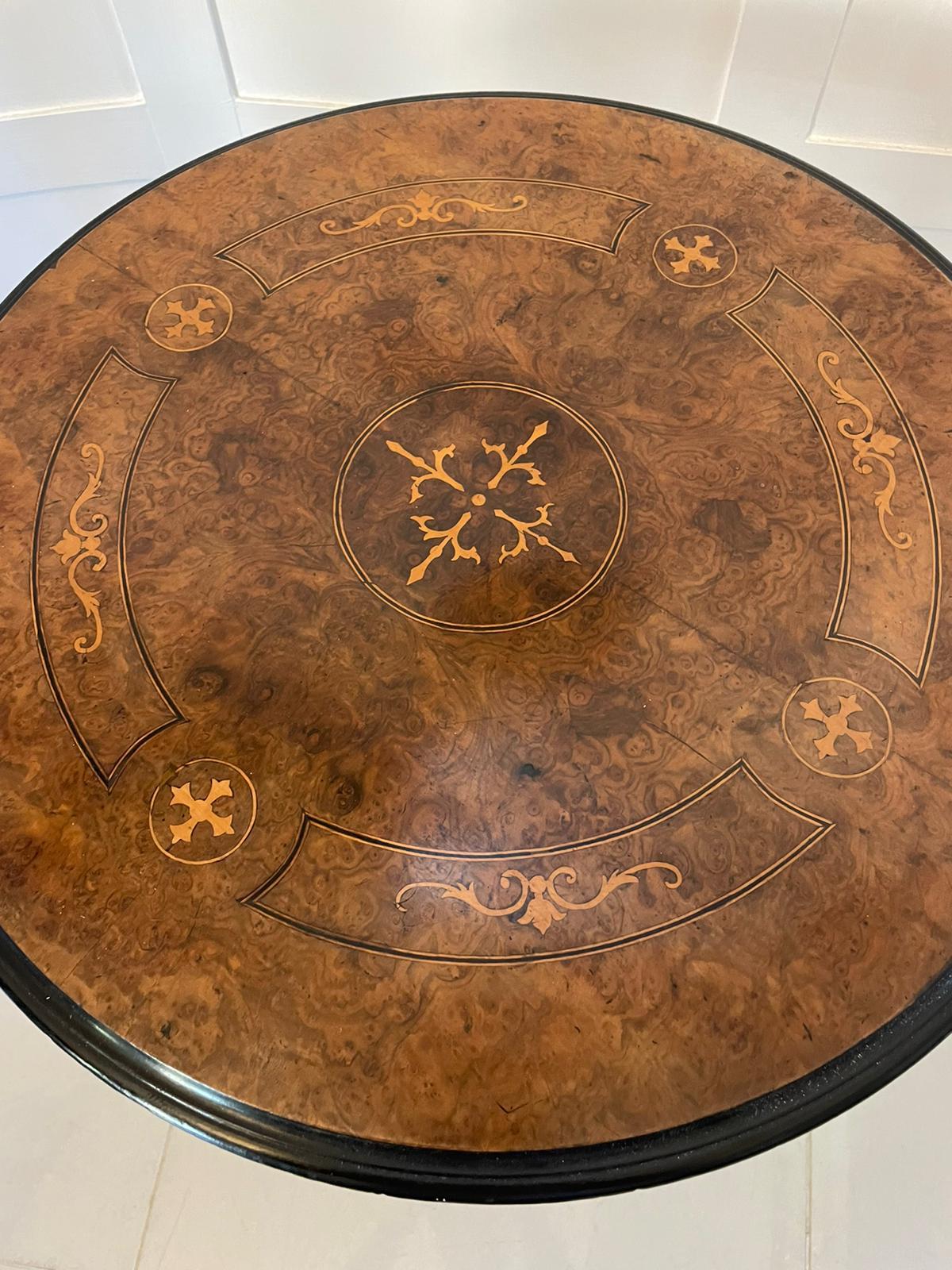 Antique Victorian quality burr walnut inlaid lamp table having an attractive and quality circular burr walnut inlaid top with a moulded edge supported by an elegant turned reeded column. It is raised on three shaped carved walnut cabriole legs with