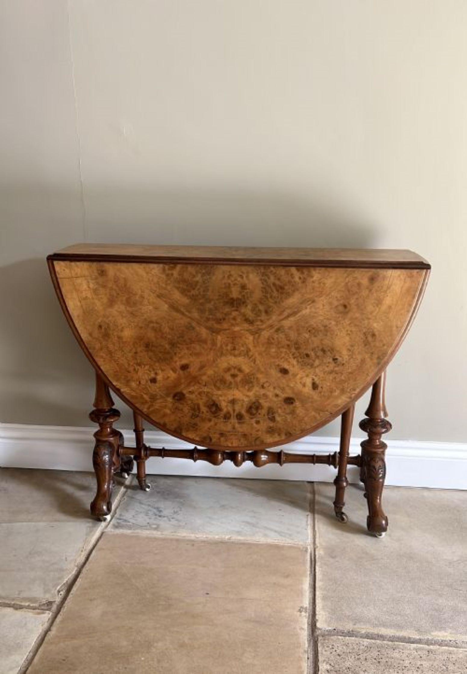 Antique Victorian quality burr walnut inlaid Sutherland table having a quality burr walnut inlaid oval top with two drop leaves and a moulded edge, supported by turned carved walnut columns swing out gate legs, standing on shaped carved cabriole