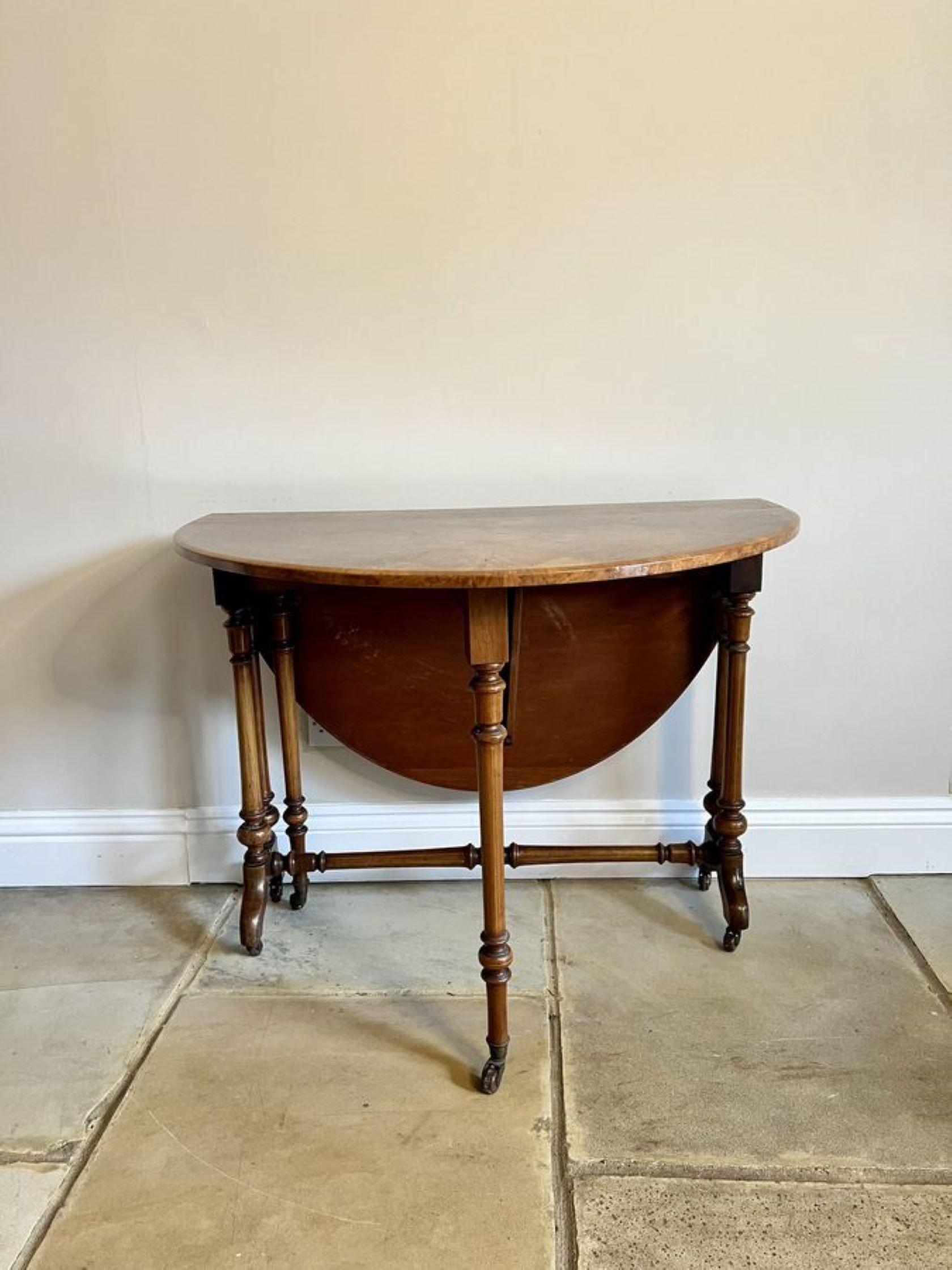 Antique Victorian quality burr walnut inlaid Sutherland table having a quality burr walnut inlaid oval top with two drop leaves and a moulded edge, supported by turned carved walnut columns swing out gate legs, standing on shaped carved cabriole