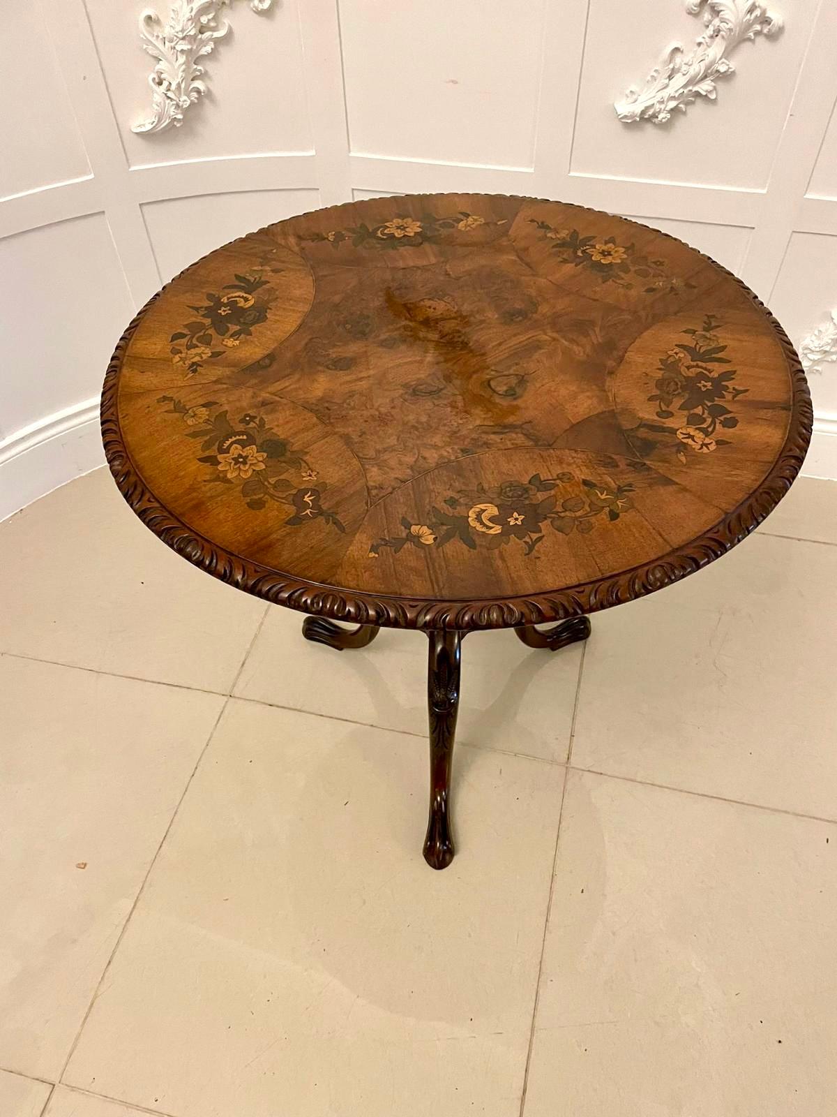 Antique Victorian quality burr walnut marquetry inlaid centre table having a quality burr walnut floral marquetry inlaid tilt circular top with a carved edge supported on a turned carved column standing on three shaped carved cabriole legs with claw