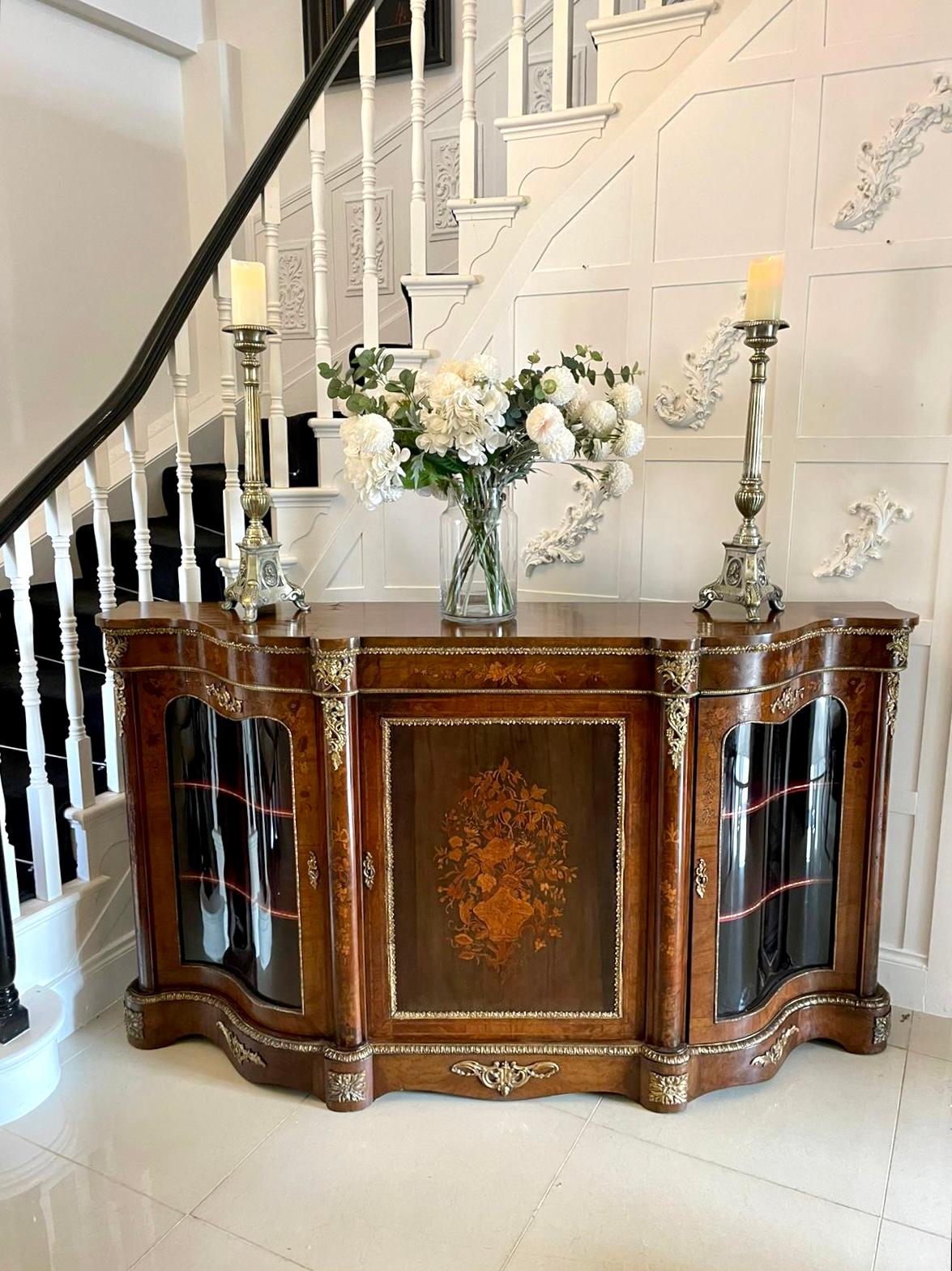 Antique Victorian quality burr walnut marquetry inlaid credenza having a serpentine shaped walnut top above a quality burr walnut marquetry inlaid ormolu mounted serpentine shaped frieze, outstanding floral marquetry door to the centre opening to