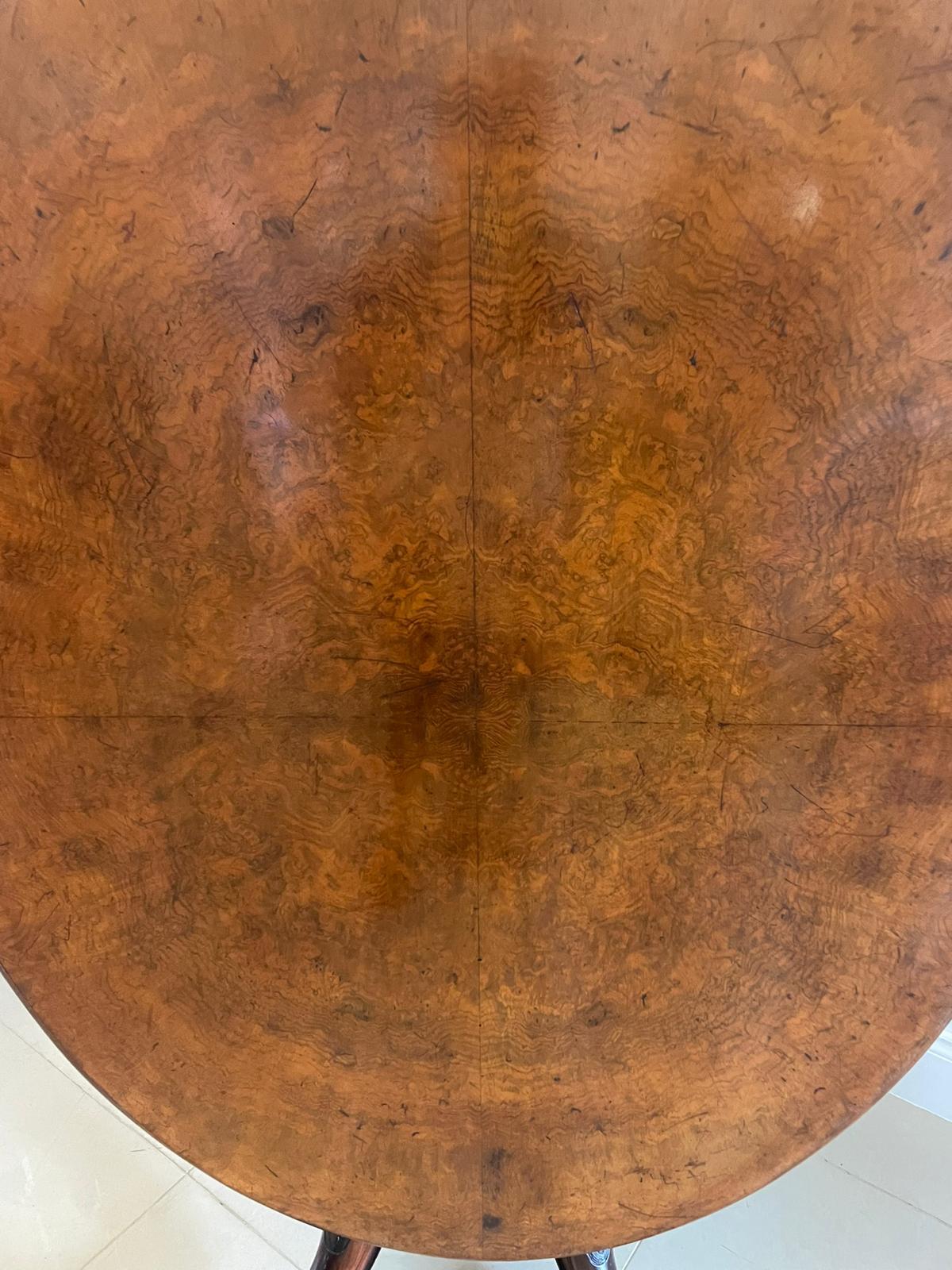 Antique Victorian quality burr walnut oval centre/dining table having a quality oval shaped burr walnut top with a thumb moulded edge, burr walnut frieze supported by a shaped turned carved pedestal column standing on shaped carved walnut cabriole