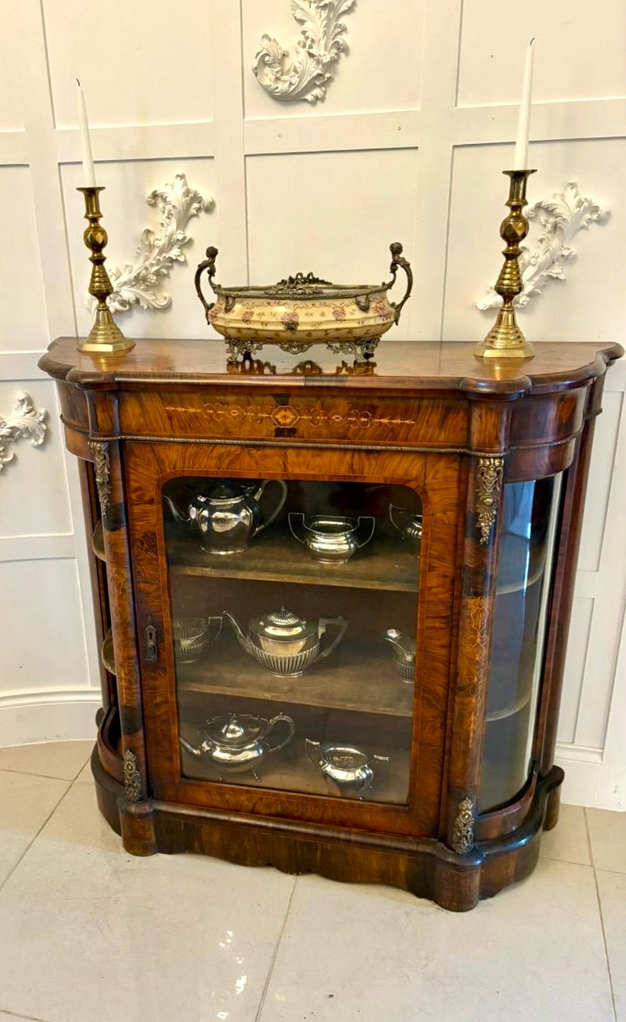 Antique Victorian quality burr walnut satinwood inlaid credenza/side cabinet having a quality burr walnut shaped top with a moulded edge above a burr walnut frieze with satinwood inlay above a single walnut glazed door opening to reveal three